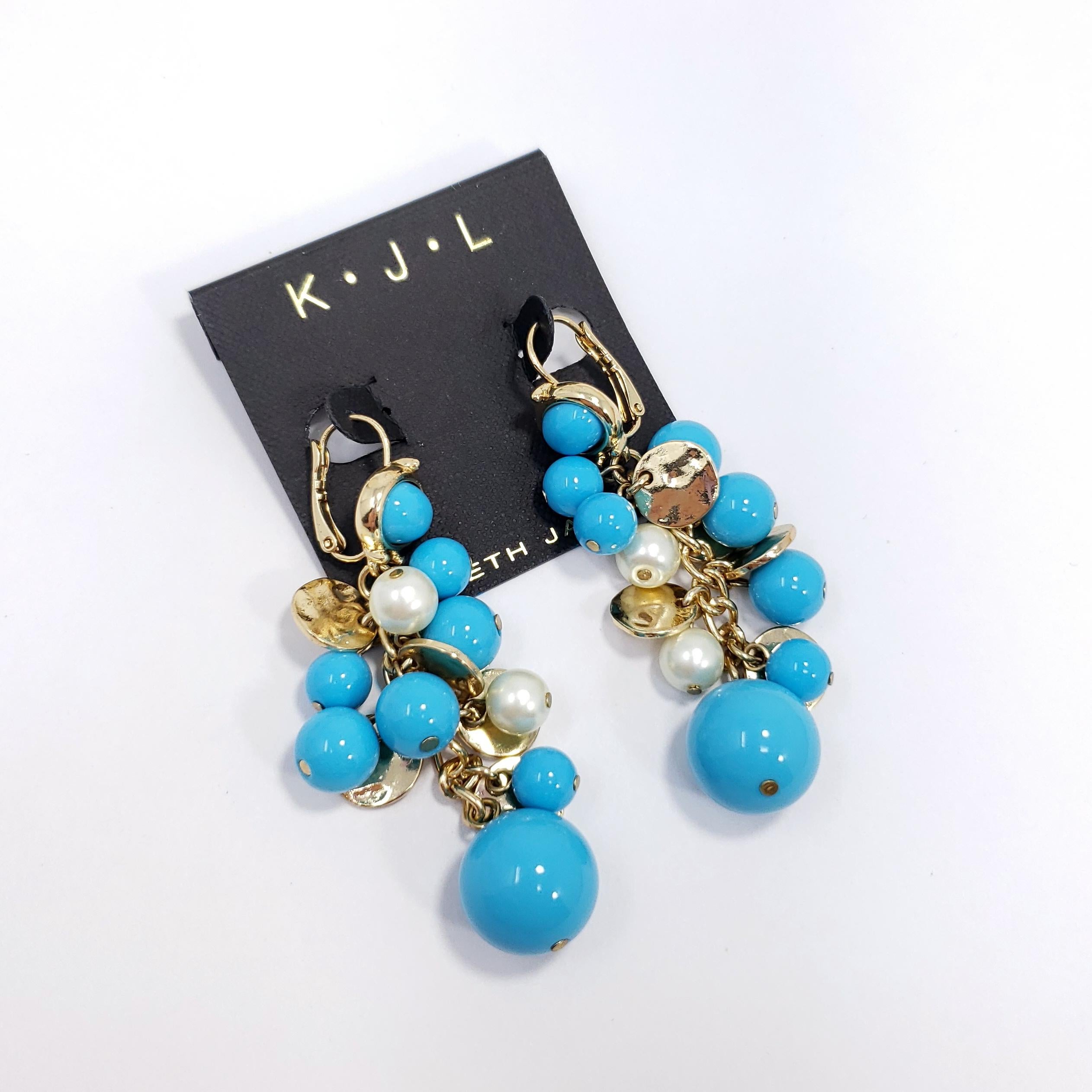 Stylish pair of cluster earrings by Kenneth Jay Lane. Add some glamour to any style with these gold-plated earrings decorated with faux turquoise and pearl beads.

Hallmarks: Kenneth Lane