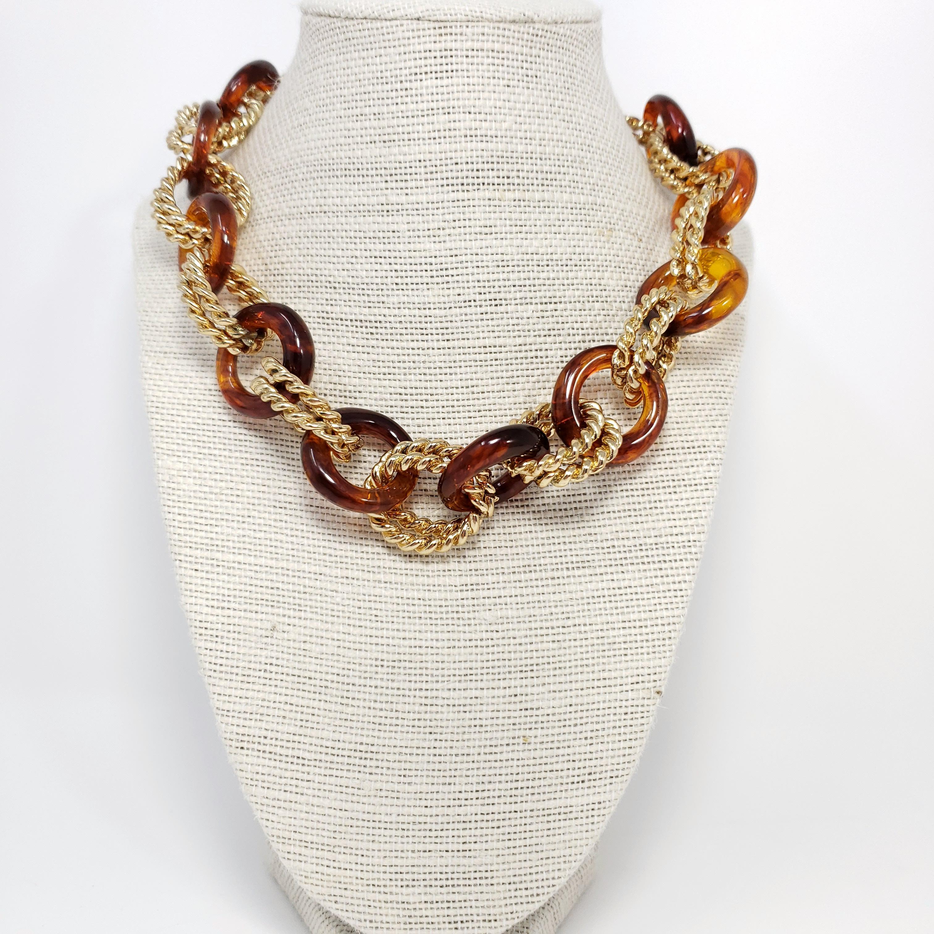 An extravagant link necklace from Kenneth Jay Lane! Features tortoiseshell resin and textured golden rings. A chic necklace for daytime or evening wear.

Toggle clasp.

Hallmarks: KJL

