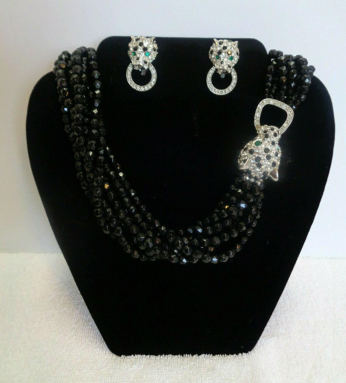 Simply Beautiful Designer Multi Strand Black Jet Necklace featuring a Sparkling Rhinestone encrusted Leopard/Panther front closure and matching Earrings by Kenneth Jay Lane. Silver tone mountings. The 8 strand necklace measures approx. 21