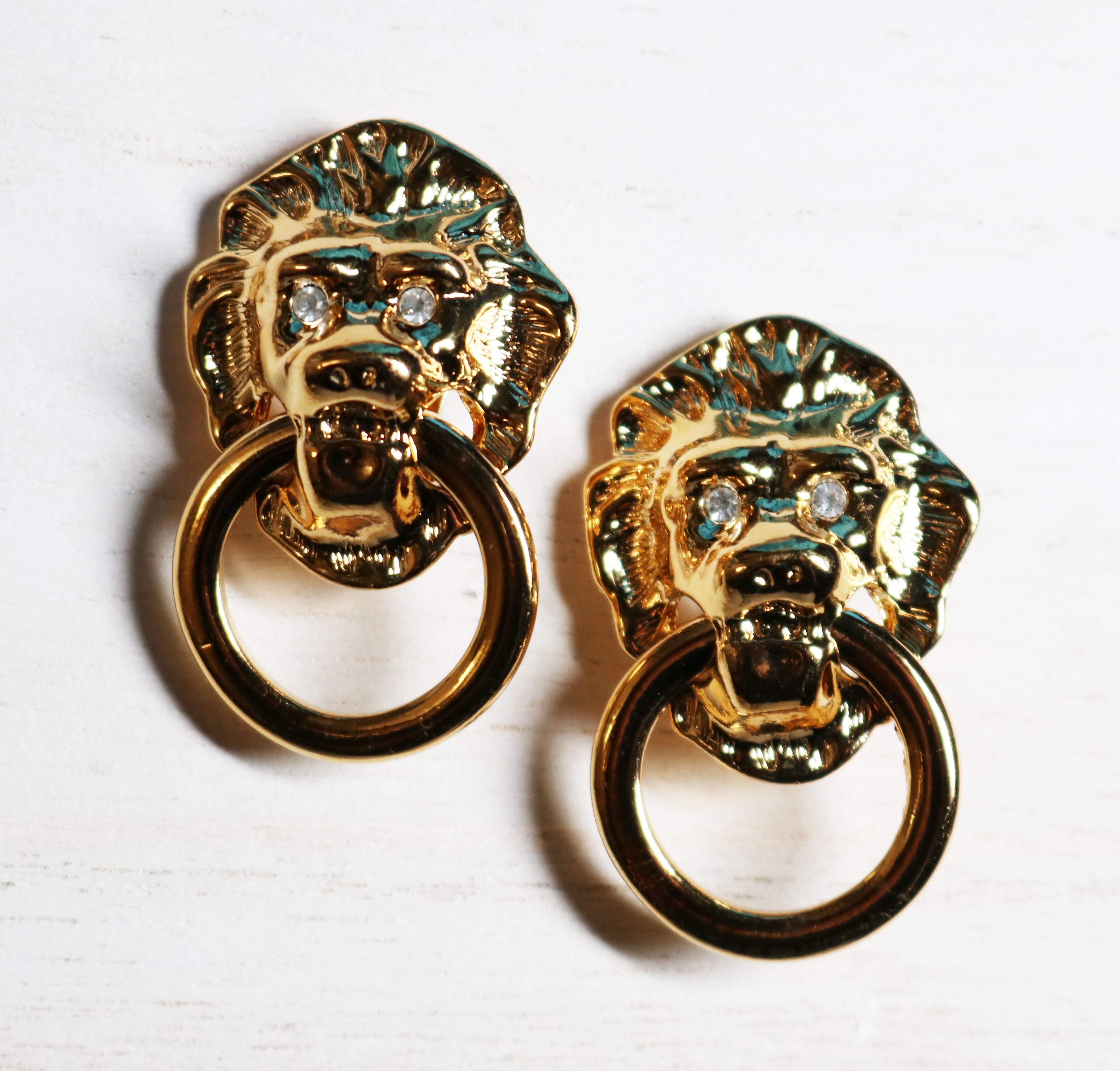 These vintage 1986, gorgeous, collectible, Kenneth Jay Lane, Lion's Head, Doorknocker earrings are designed by the 'jeweler to the world's most admired women' for the AVON Society and these iconic pieces are a lustrous gold tone with rhinestone