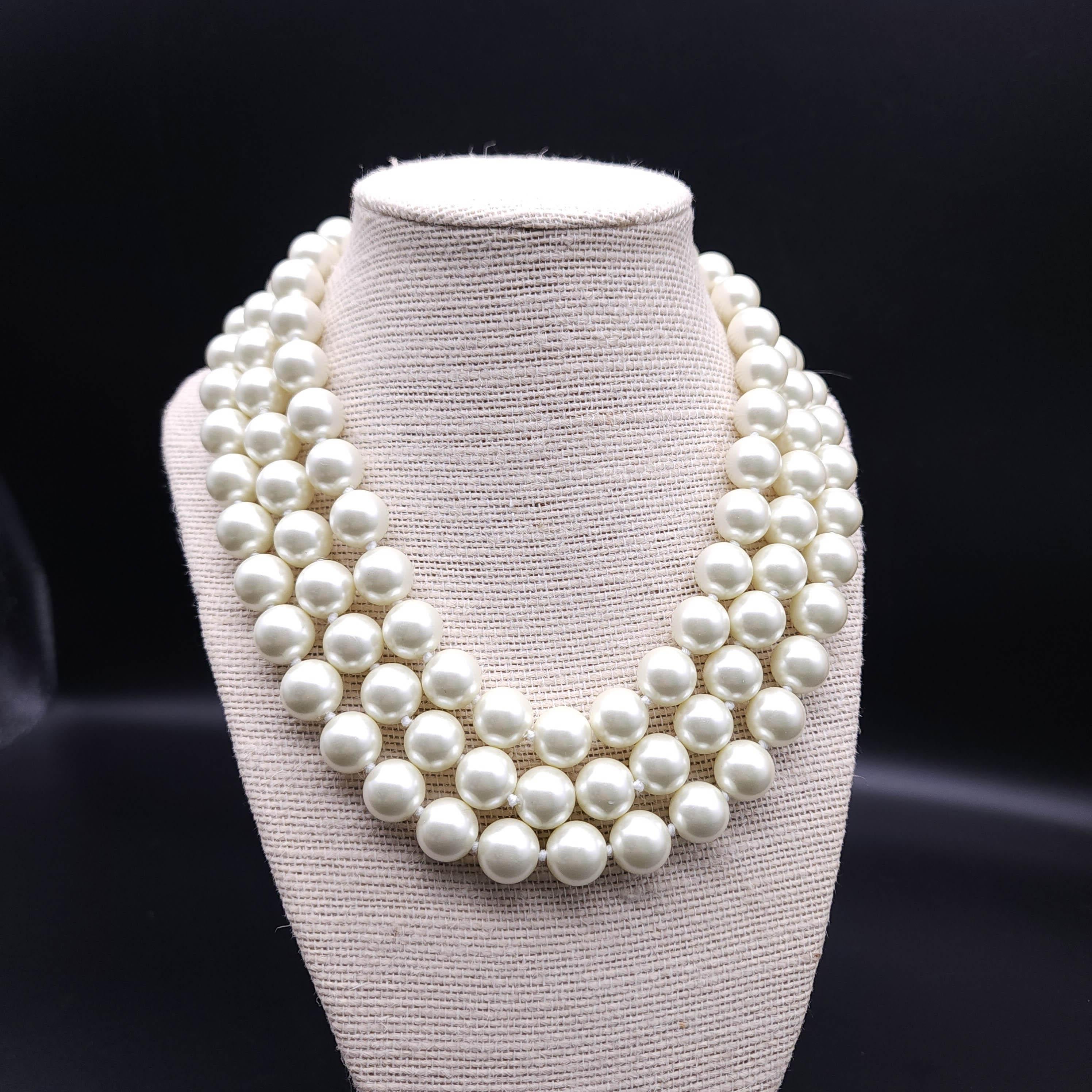 Add a touch of timeless elegance to your jewelry collection with the Kenneth Jay Lane multi-strand faux pearl necklace. Crafted with meticulous attention to detail, this exquisite necklace features:

Three Strands of Lustrous Faux Pearls: The