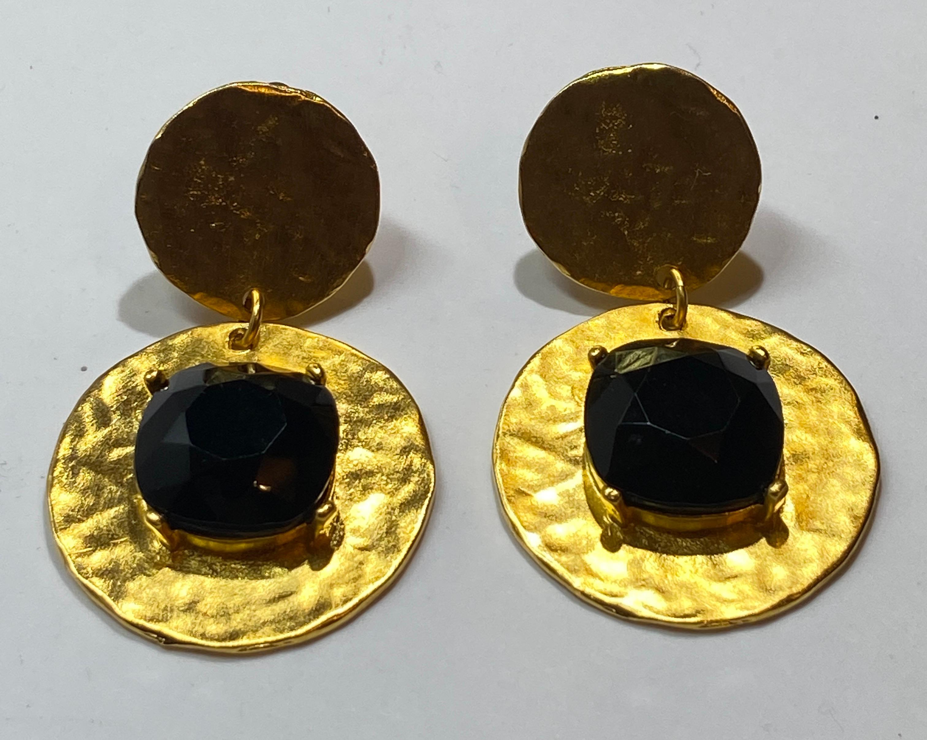 Kenneth Jay Lane's wonderfully elegant polished gilded gold hardware accented with a black lucite center clip-on earrings measures 2 1/2 inches in length. The width measures 1 inch and 1 1/2 inches. Designer's signature name is etched on the