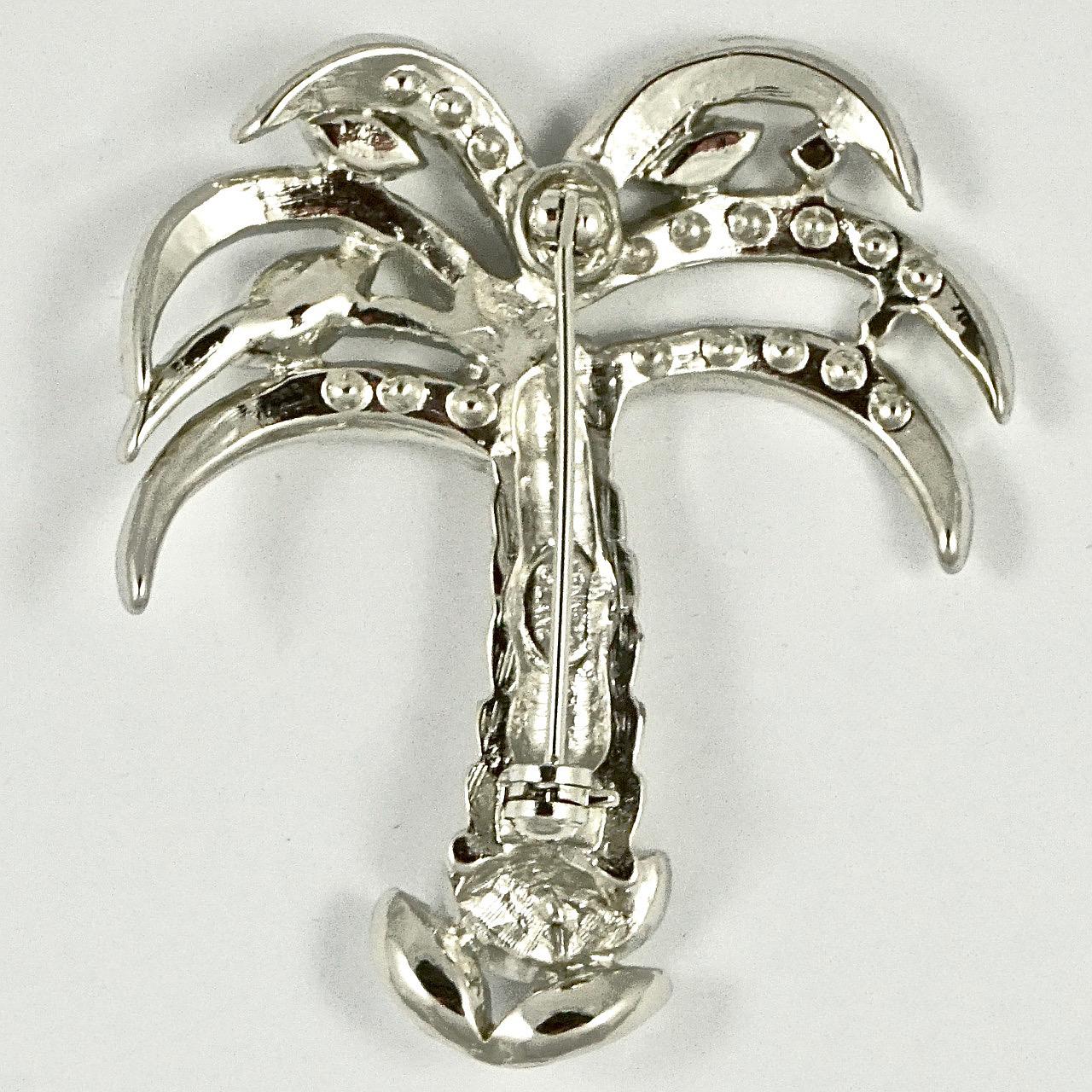 Wonderful Kenneth Jay Lane silver plated palm tree brooch, set with marquise and round rhinestones. Measuring length 4.8cm / 1.88 inches by width 4.1cm / 1.6 inches. The brooch is in very good condition.

This is a stylish sparkling rhinestone