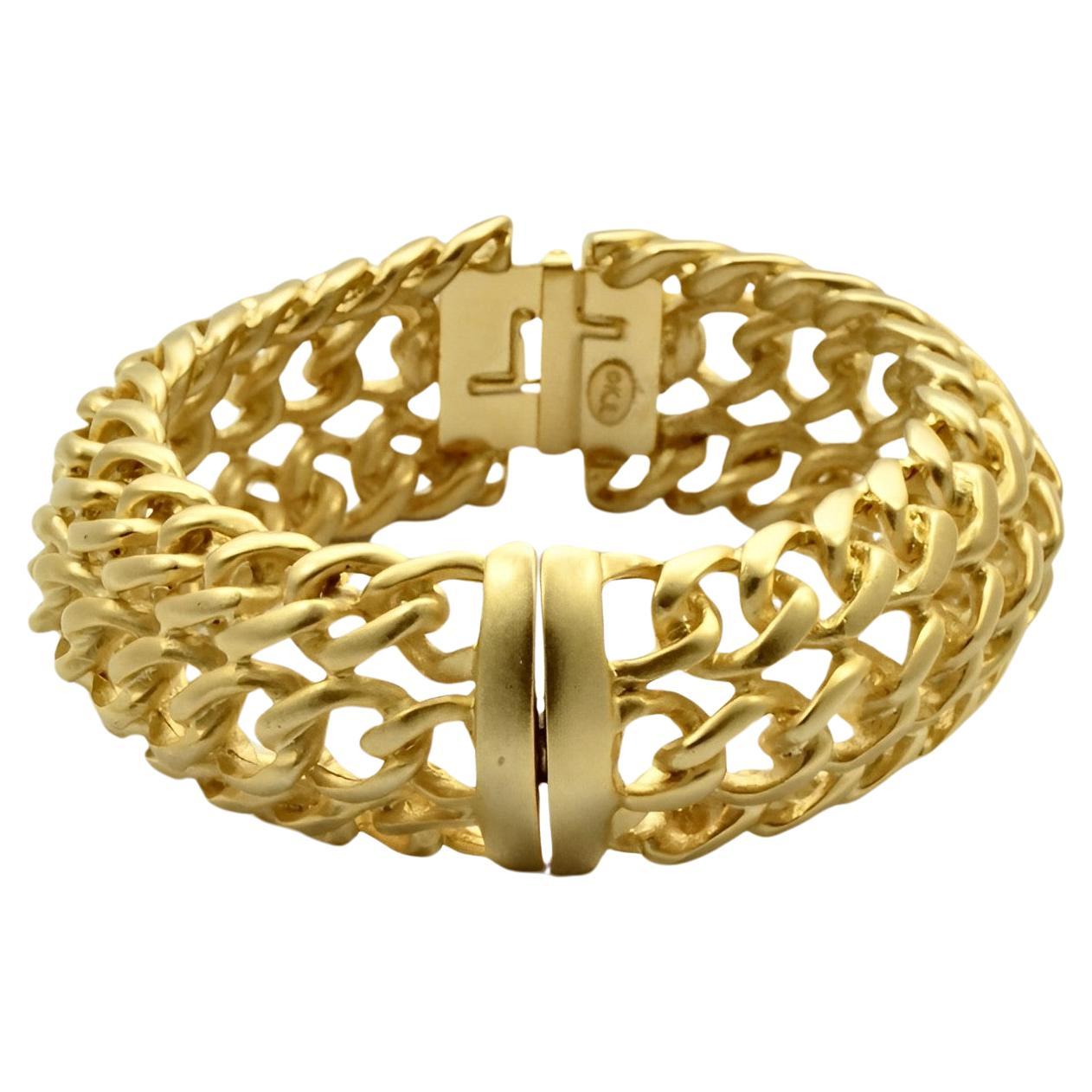 Kenneth Jay Lane matt gold plated triple chain bangle bracelet, with a magnetic clasp. Inside diameter 5.7 cm / 2.24 inches, outside diameter 7.6 cm / 3 inches, the width is 2.3 cm / .9 inch. The bracelet is in very good condition.

This is a