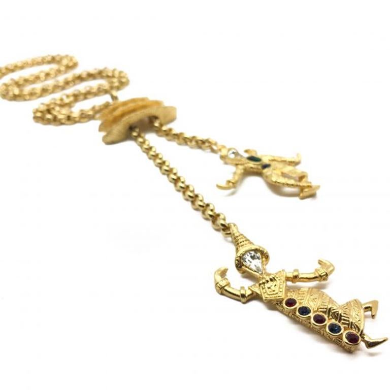 A Kenneth Jay Lane of KJL Pagoda Necklace from the 1990s. Featuring a lovely long gold pated chain and a quirky Pagoda pendant adorned with crystal set gold plated Asian, possibly Thai Dancers. The Pagoda is removable from the chain and can