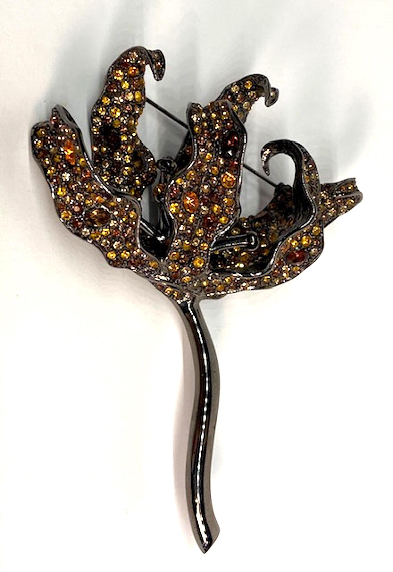 Beautifully made and sculptural is this Kenneth Lane three dimension tiger lily brooch. The finish is a charcoal gun metal color. The petals are set with round and oval gold, champagne and amber brown rhinestones. The brooch is 4 inches wide, 5.25