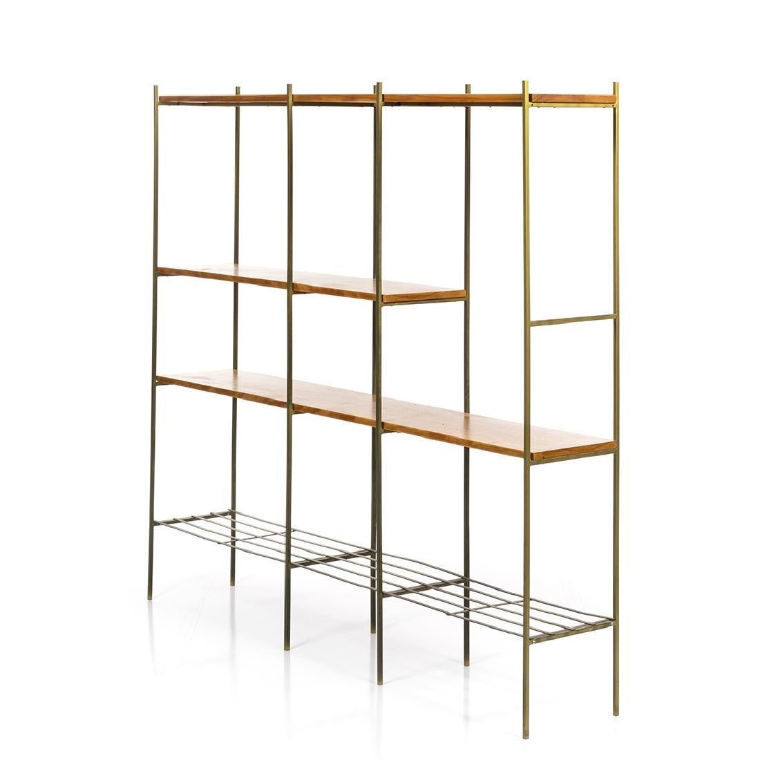 Midcentury Kenneth Lind room divider made with vintage walnut and metal, circa 1950s. Fair condition, some of the bottom shelf is slightly bent as seen in the photo, and the bottom left corner must be reattached, but remains functional.