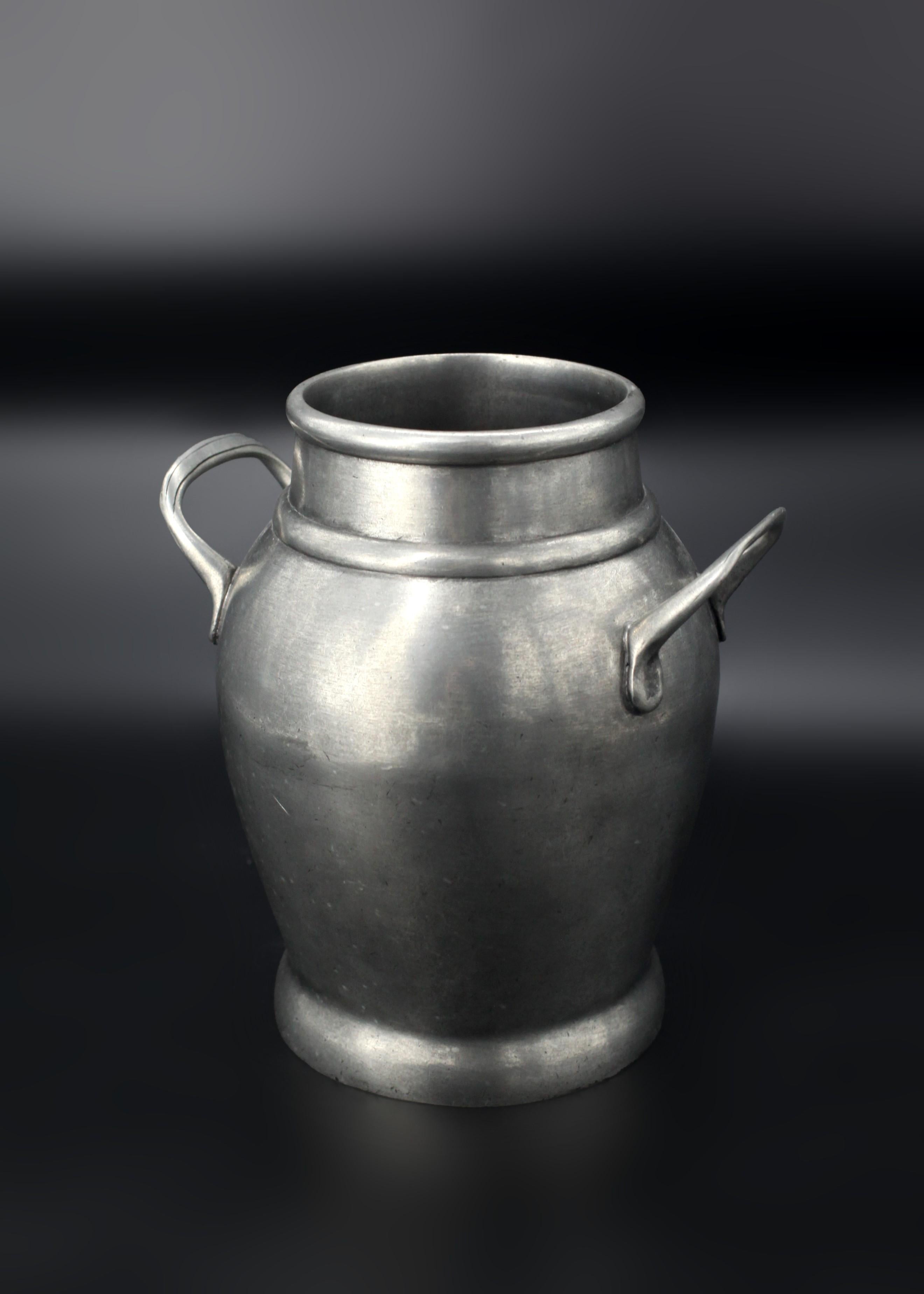 Robust and unyielding, this Kenneth Turner Pewter Vase commands attention with its striking presence. Crafted in the 20th century by renowned designer Kenneth Turner, the hefty vase’s unmistakable quality communicates an air of practicality and