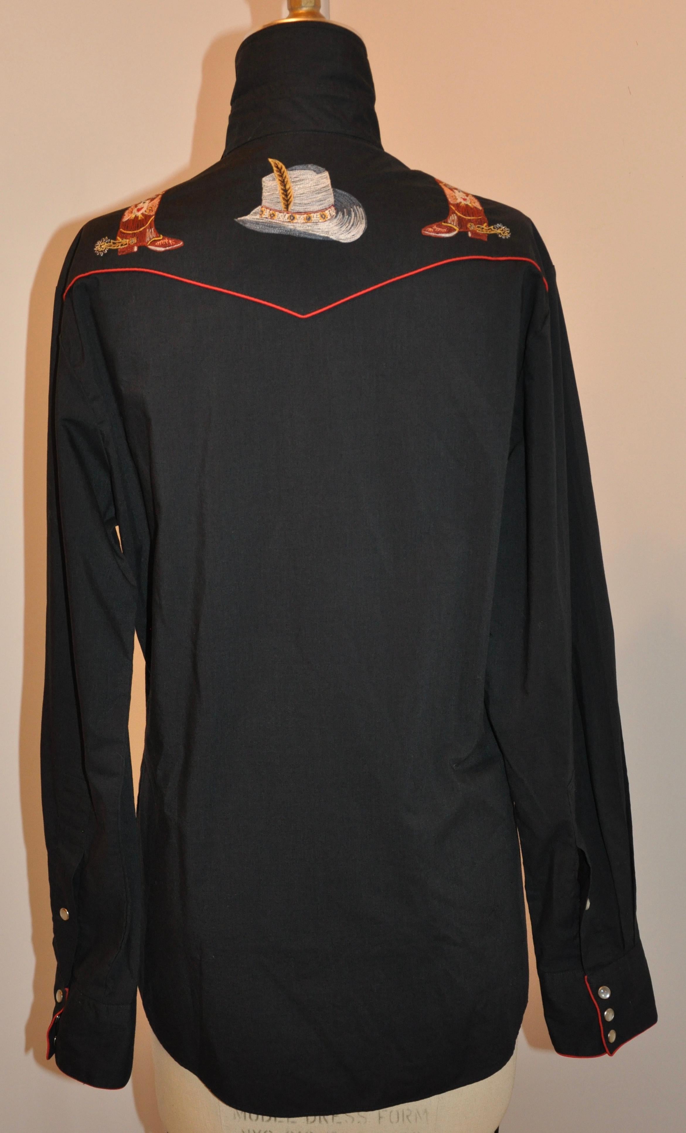     Wonderfully detailed, Kennington tapered Rocking Ranch  black cotton shirt is accented with red piping and highlighted with detailed embroidering. Instead of buttons, the shirt has 