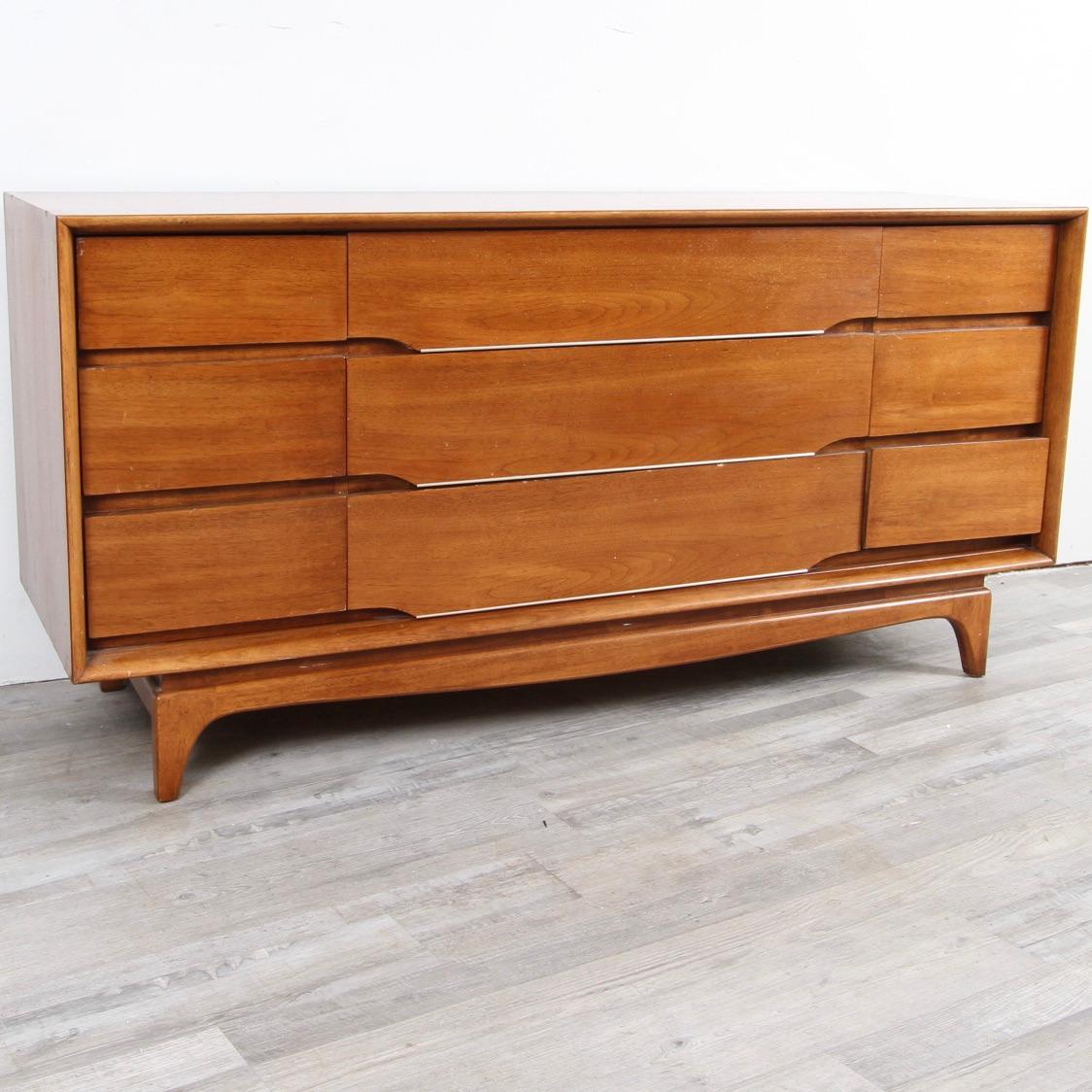 This beautiful Kent Coffey dresser is part of a beautiful bedroom set which can be sold together for a lower price. Set includes the dresser featured in this listing, and a highboy dresser.
This triple dresser features three rows of three drawers.