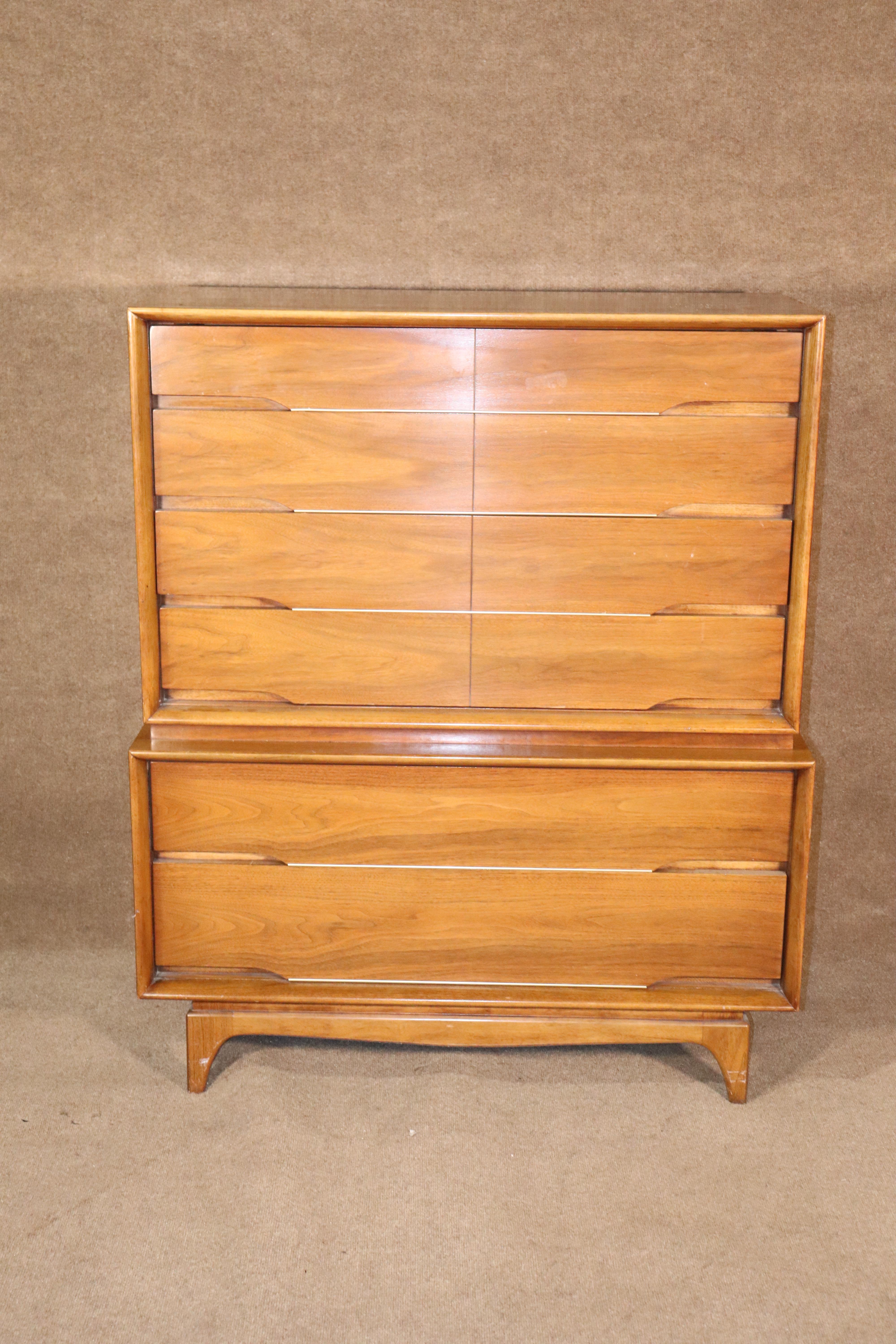 Full mid-century modern bedroom set designed by Kent Coffey. Warm walnut grain with accents of brass trim.
Tall dresser: 53