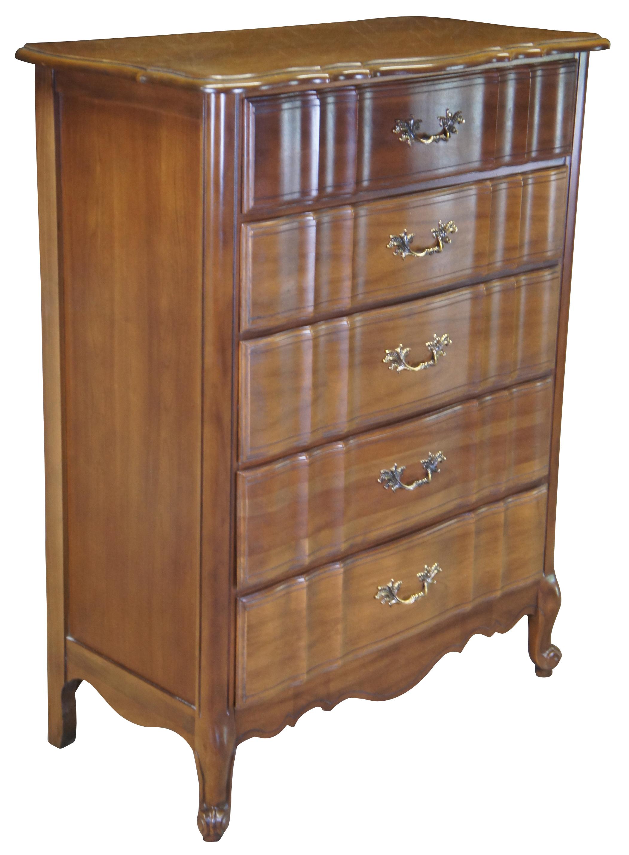 Vintage fruitwood chest or dresser by Kent Coffey. From the Marqee French collection, featuring French Provincial styling with scalloped / serpentine top over five drawers and scrolled cabriole feet. 300-140.
  