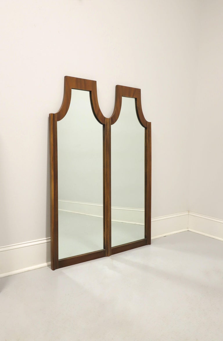 A Mid-Century Modern dresser or wall mirror by Kent Coffey, of Lenoir, North Carolina, USA, from their Marquee Modern line. Dual mirror glass in a combined solid walnut frame with unique shape. Made circa 1966.

Style #: 100-131

Measures: 36.25 W