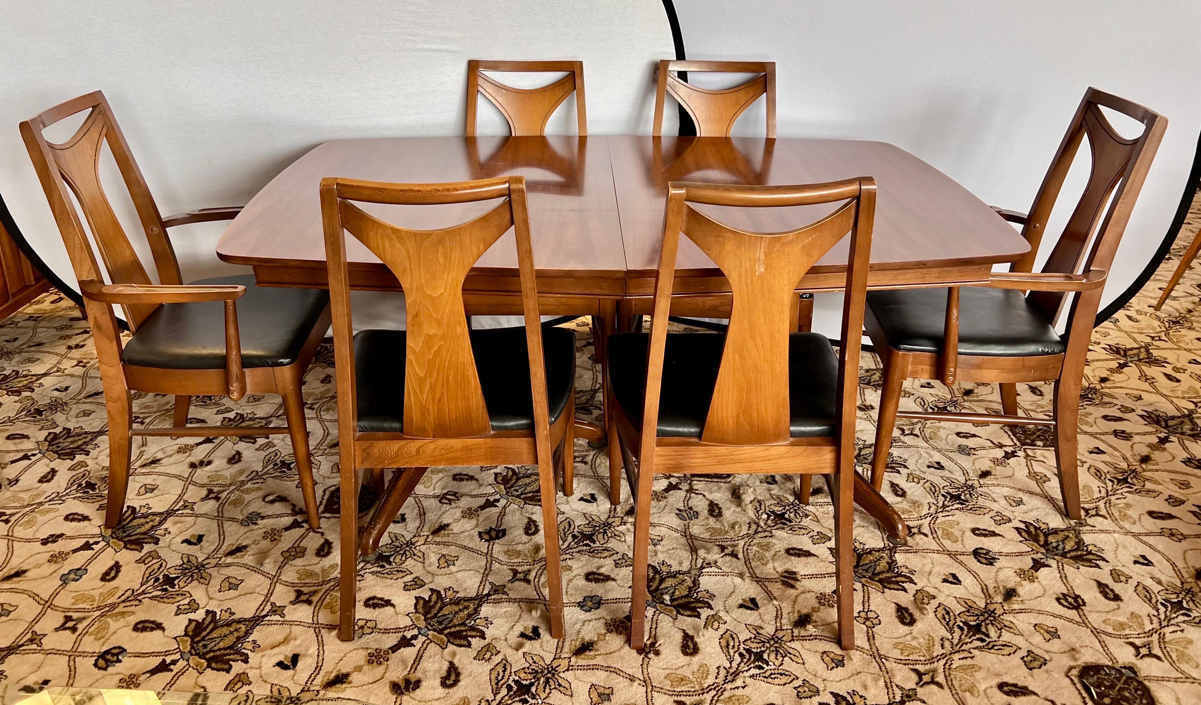 Expandable mid century classic Kent Coffey dining room set that includes table, chairs and one leaf.  The table expands from 64