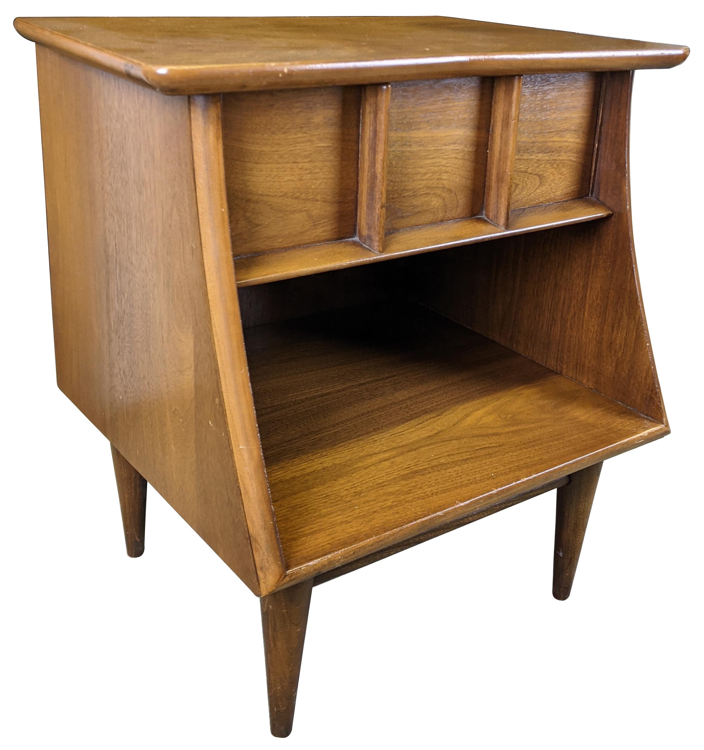 Vintage sculptural shaped nightstand or end table by Kent Coffee. Made from continental walnut with dovetailed drawer and lower cubby with tapered legs, circa 1960s. #6900.
  