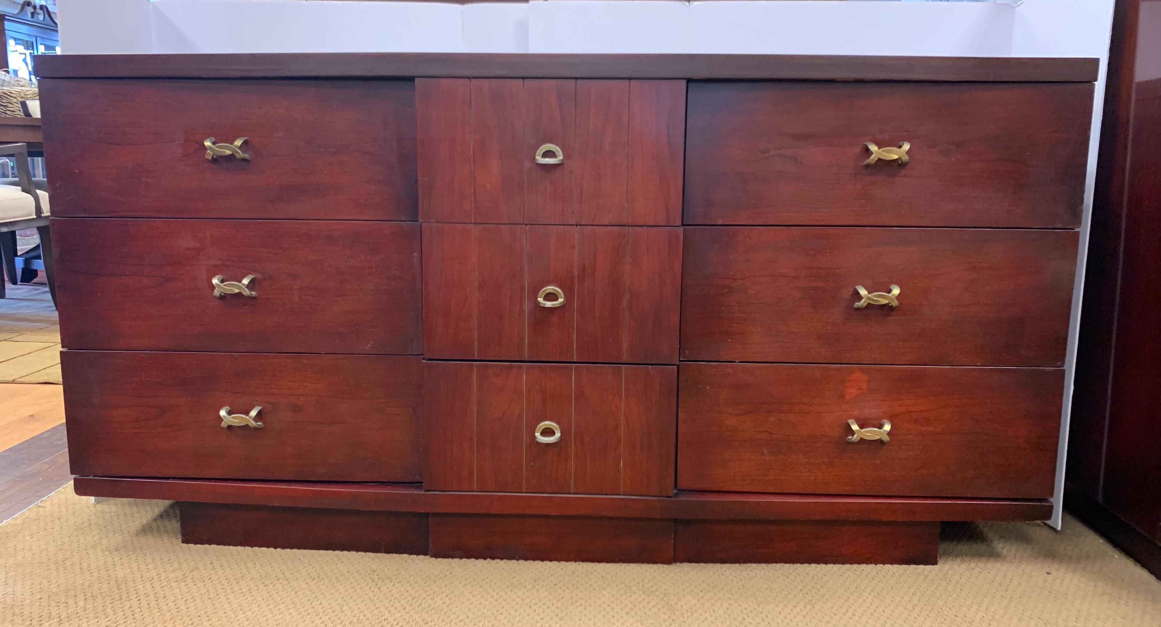 Iconic, signed midcentury dresser from Kent Coffey. This is part of the coveted Titan line. Made in the USA and featuring nine spacious drawers, all adorned with sought after original drawer pulls. 