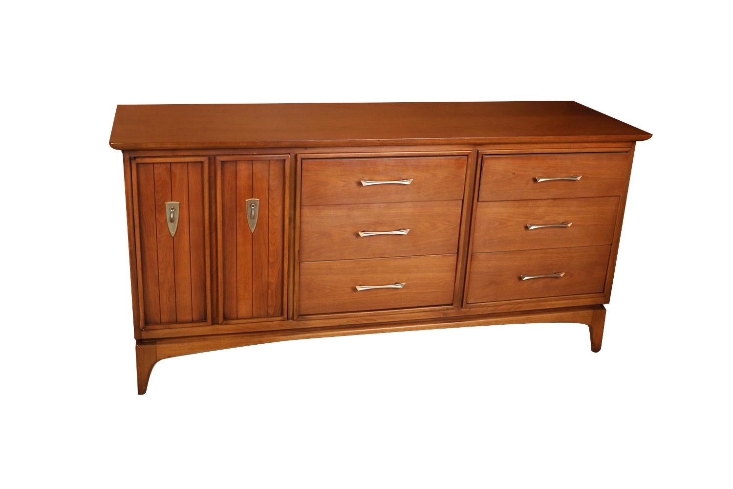 Mid-Century Modern dresser, the “Wharton” line by Kent Coffey. Minimalist Danish Modern inspired profile. A handsome example of American craftsmanship. Stunning walnut dresser with copper accents. Exquisitely designed with incredible lines and