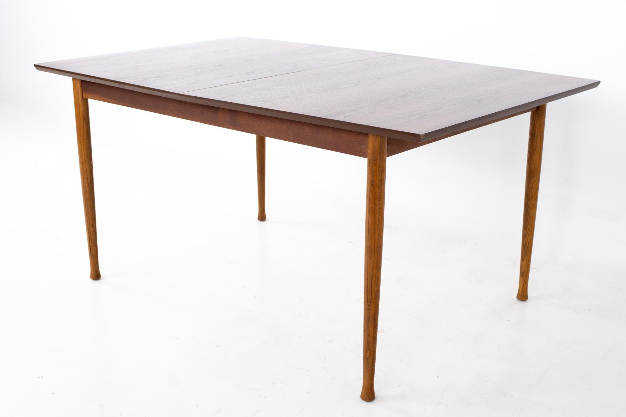 Kent Coffey Perspecta mid century walnut surfboard dining table
Table measures: 60 wide x 40 deep x 29 inches high; the leaf is 12 inches wide, making a maximum table width of 72 inches when used, and has a chair clearance of 26 inches

All
