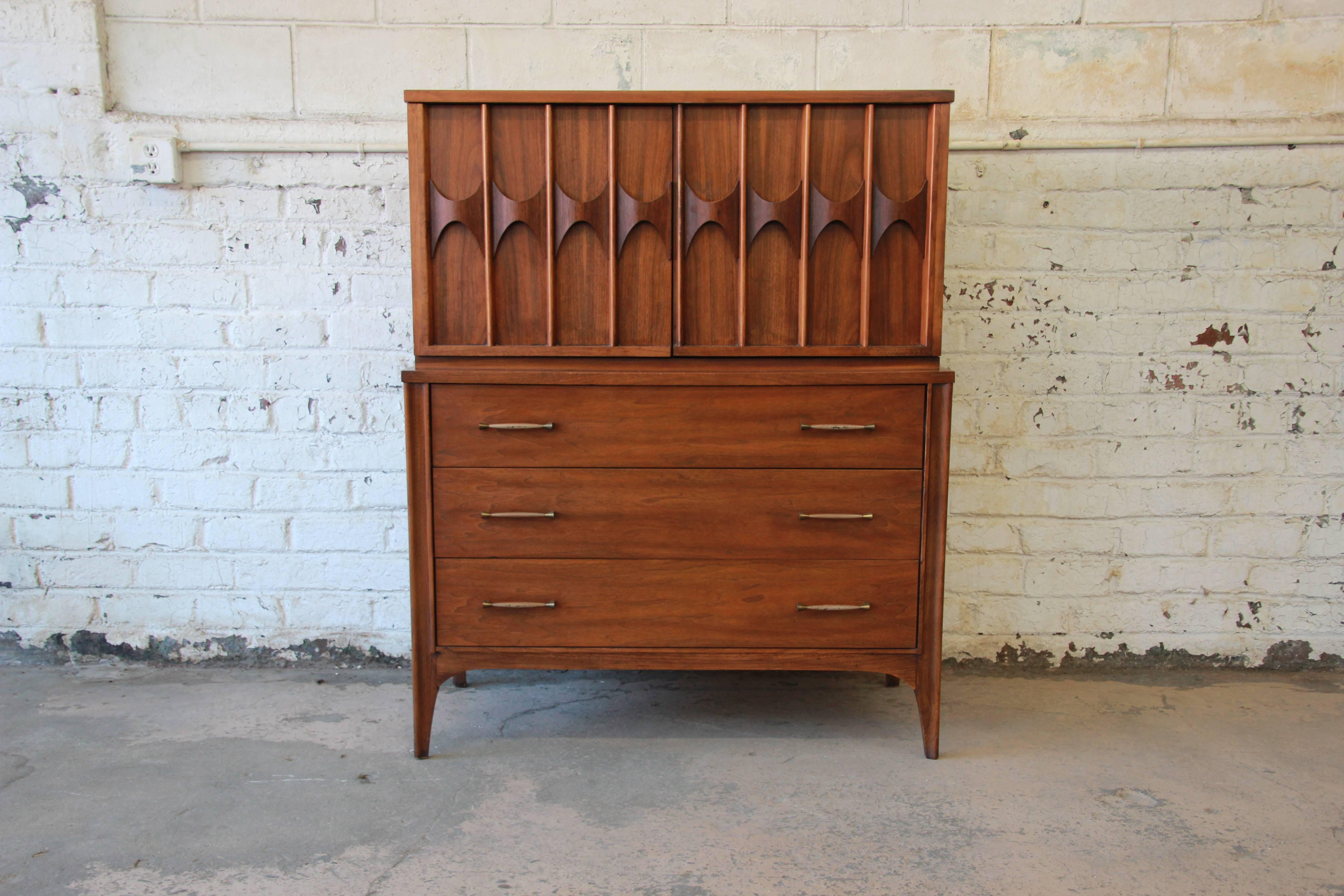 A stunning Mid-Century Modern sculpted walnut and rosewood gentleman's chest from the 