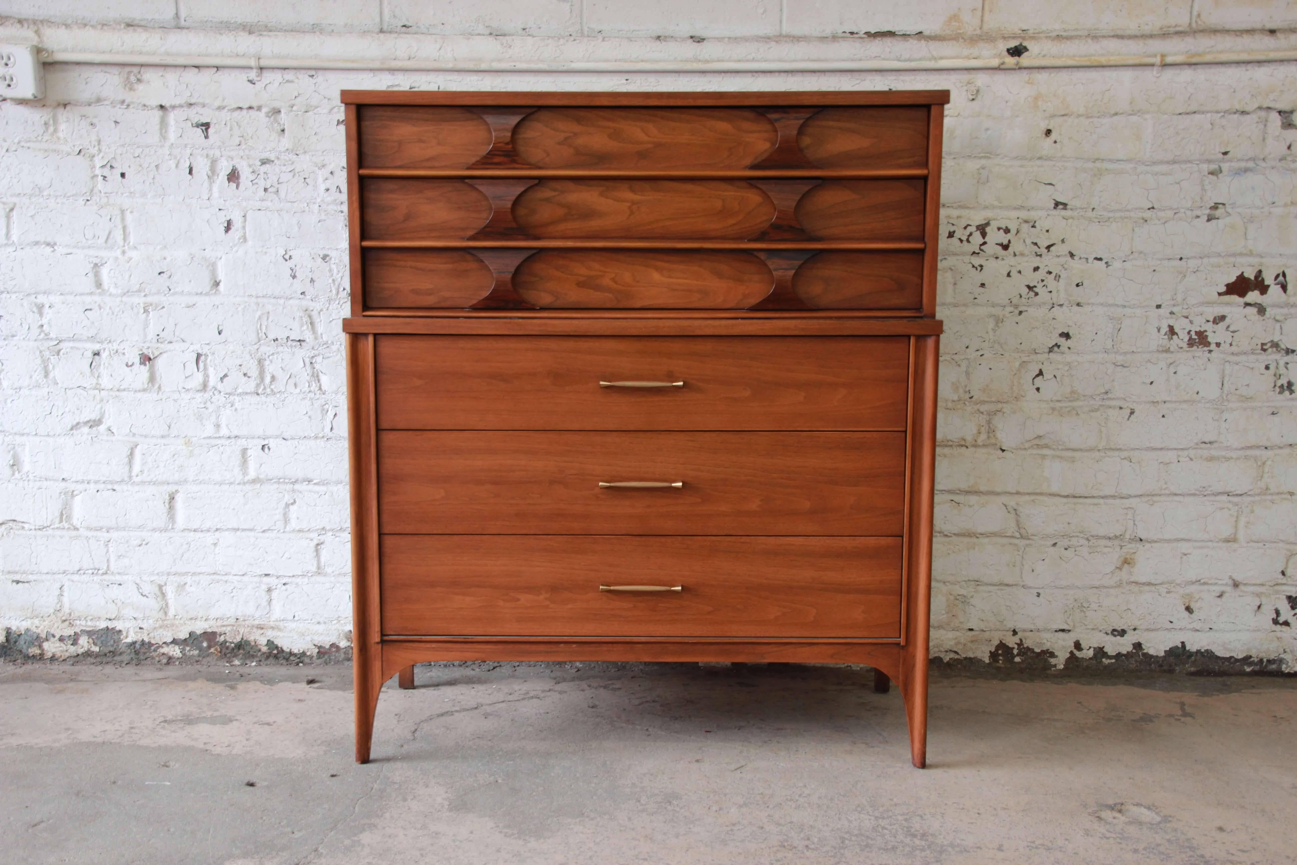 Offering a very nice Classic Mid-Century Modern designed dresser by Kent Coffey. This piece is part of the Perspecta line and has a beautiful walnut grain. The top portion of the dresser has unique sculpted rosewood pulls and two large drawers for