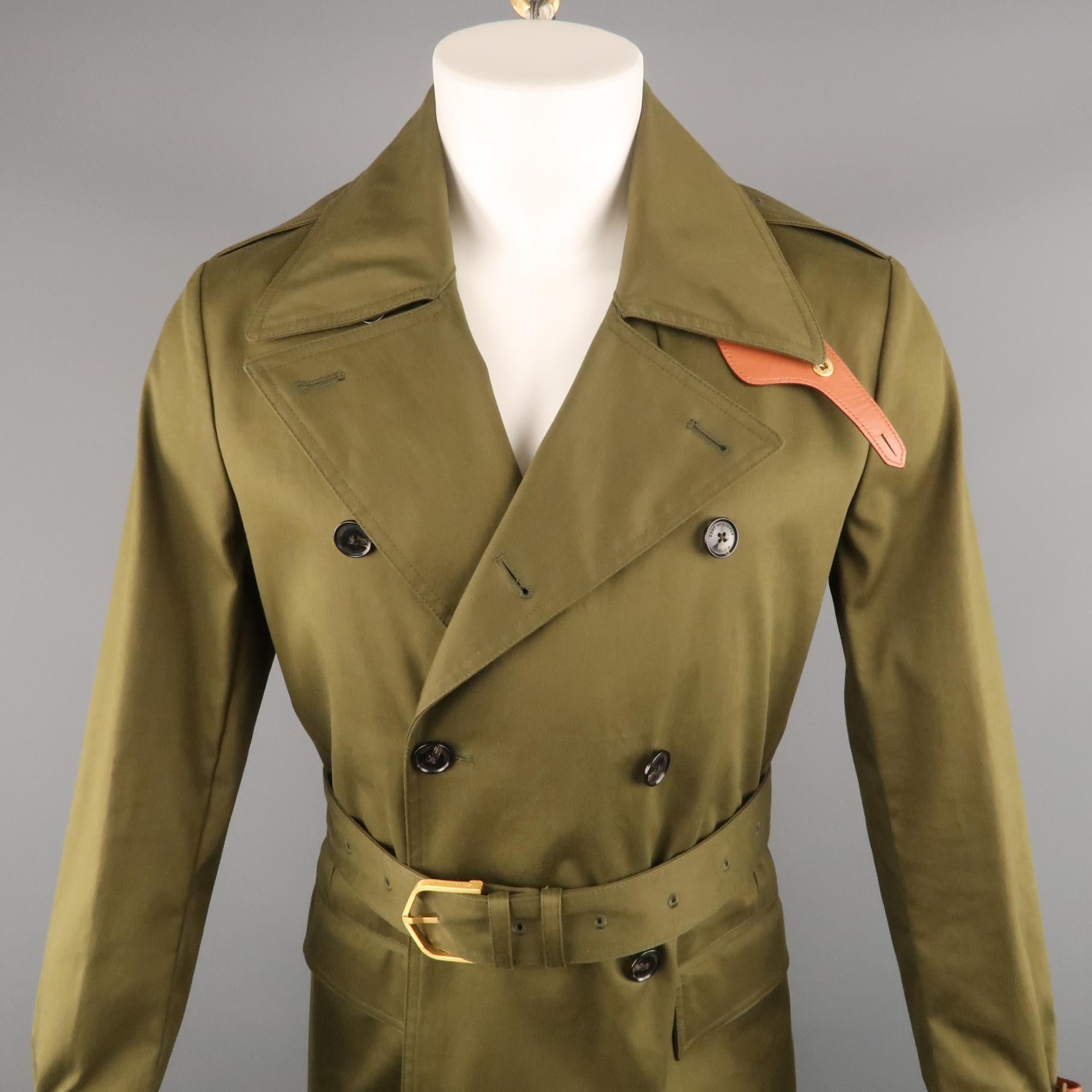KENT CURWEN trenchcoat comes in a olive cotton featuring a belted style with brown leather details, double breasted, notch lapel, and flap pockets.

Excellent Pre-Owned Condition.
Marked: S

Measurements:

l Shoulder: 17.5 in.
l Chest: 40 in.
l