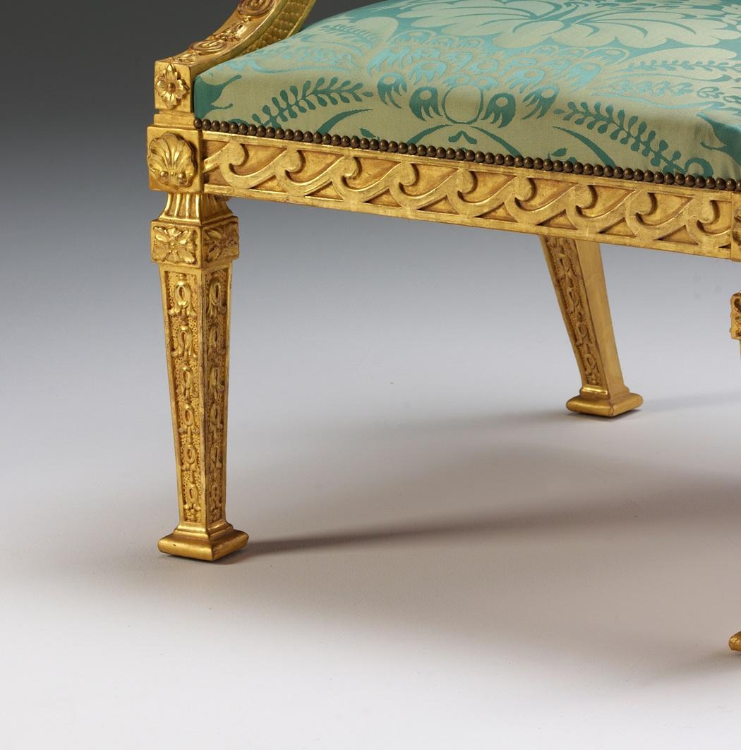 A William Kent design gilded wood library armchair with tapering square legs, acanthus and shell carvings, vitruvian scroll rails and swept arms with acanthus roundel and bell-flower details.

We are currently working to a 30-36 week lead time.