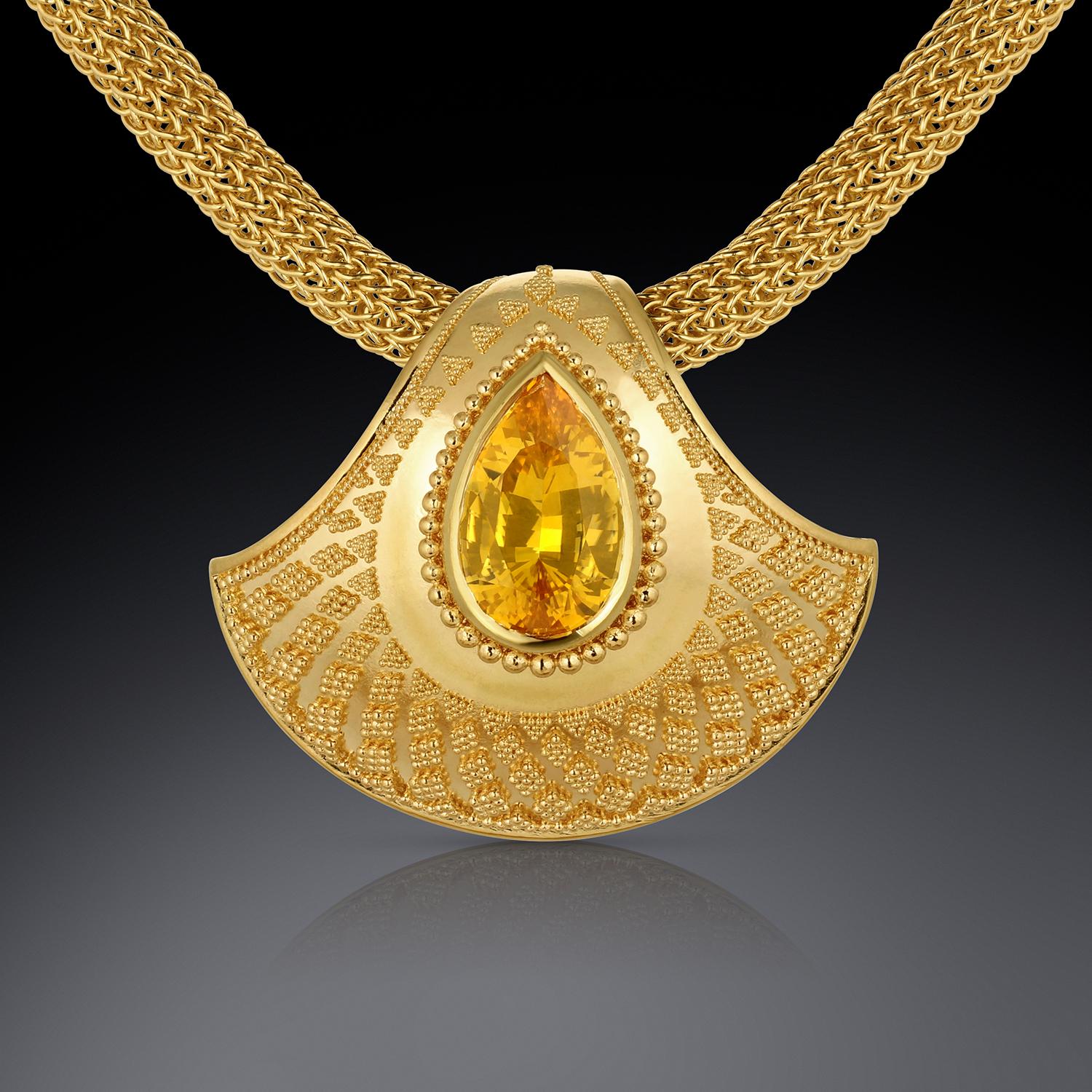 Kent Raible's newest Shell Pendant displays a stunning spray of tapering granulation on an elegant shell form, Showcased in this beautiful piece, is a rich, 5ct Golden Sapphire. This stone has superior color and sparkle. The gem is large, but also