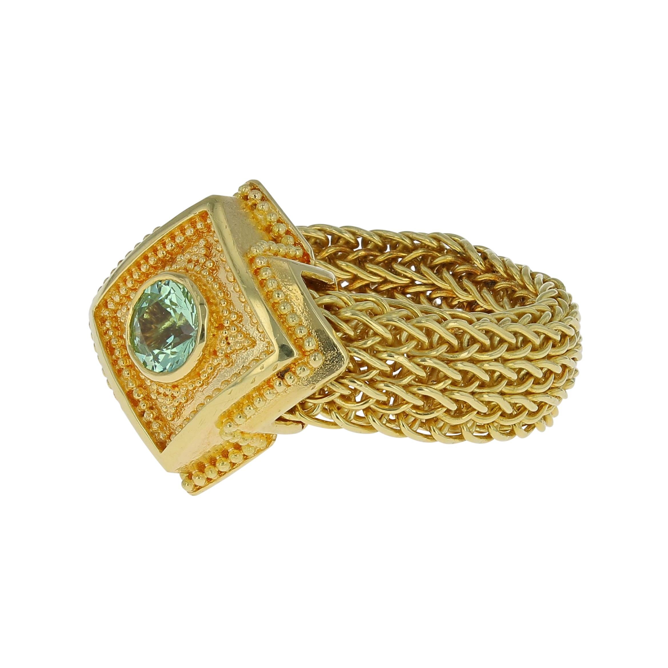 A unique ring from the Kent Raible 'Studio Collection'! This ring features the Raible classic gold granulation, but uses a flexible mesh, hand woven chain band! The soft Green Grossular Garnet adds a wonderful sparkle to this unique design. Do you