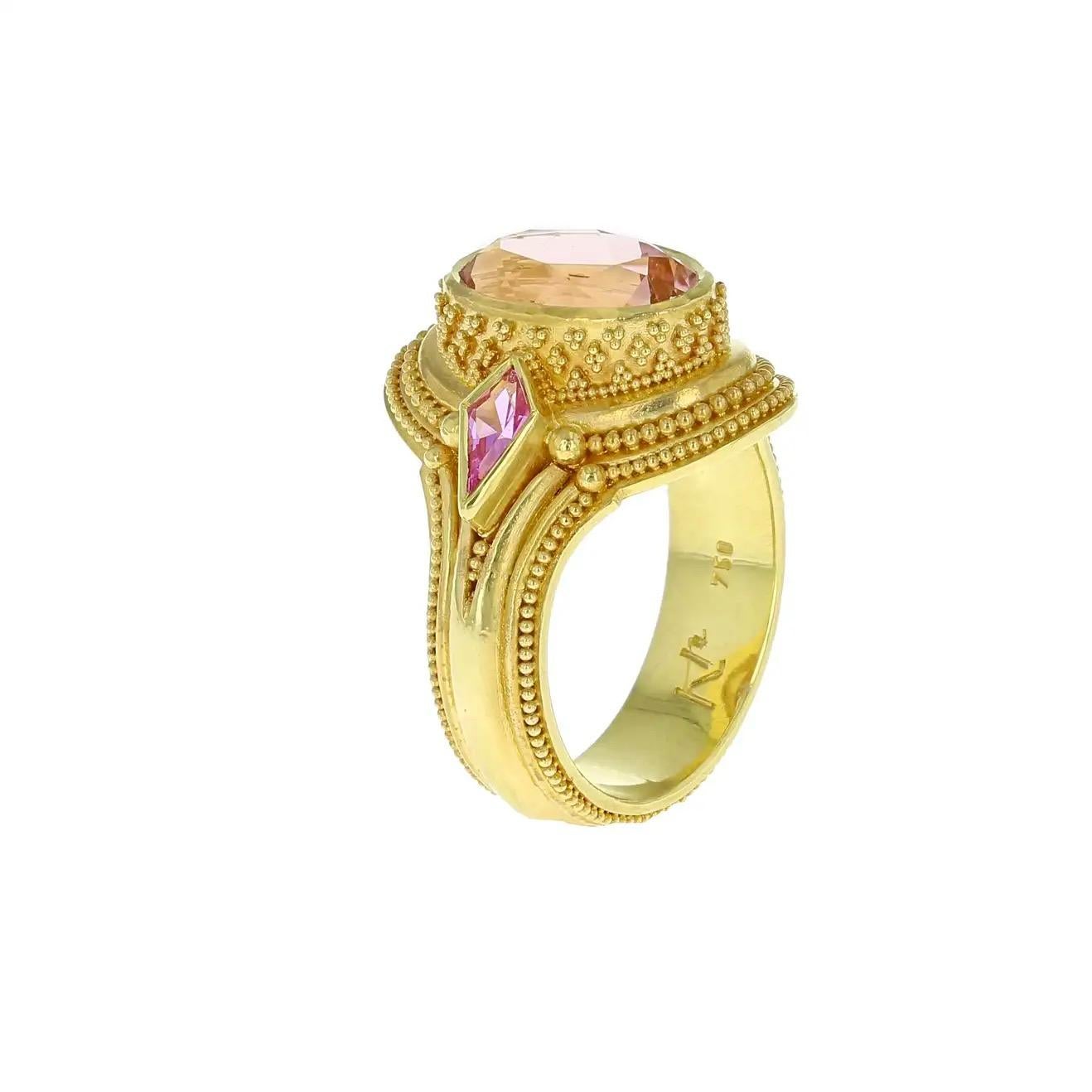 From the Kent Raible Masterworks collection we bring you this new and stunning bespoke ring featuring a gorgeous Peachy-Pink Tourmaline accented with Kite shaped Pink Sapphires. Check out all the intricate and finely crafted detailing on this ring!