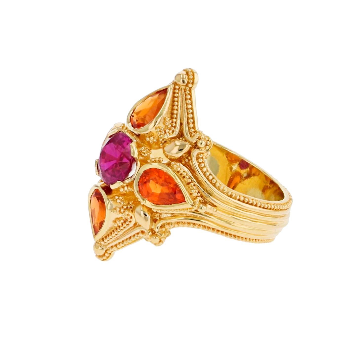 This stunning Kent Raible ring boasts the gorgeous and brilliant colors of Ruby and Mandarin Garnet. The delicate detail, elegant design and impeccable craftsmanship are all trademarks of this nationally celebrated visionary artist and master