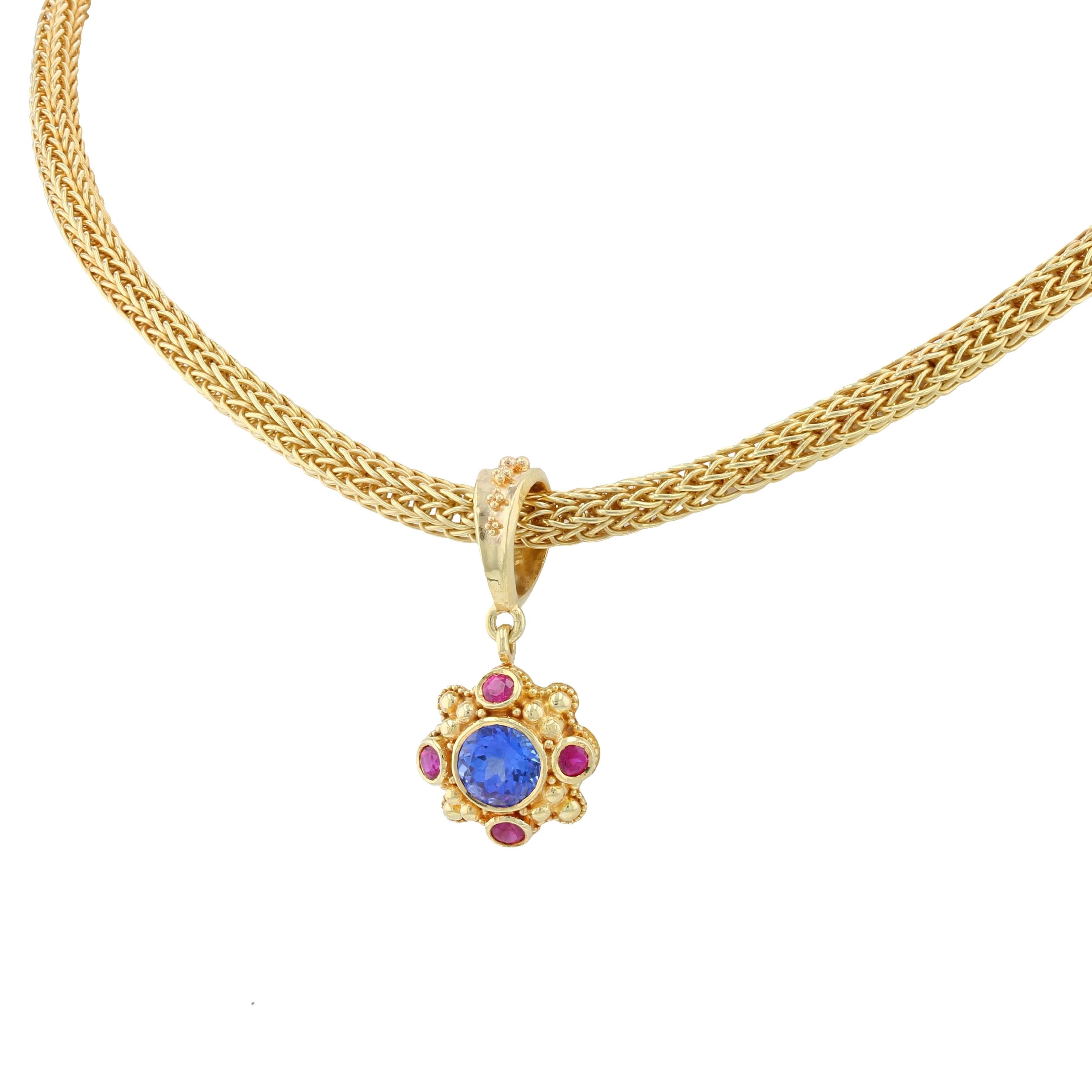 From the Kent Raible limited edition 'Studio Collection' we have this gemmy Pendant in the deep rich colors you only get with Tanzanite and Ruby! Raible has focused on making those gems pop with just his gold granulation as the frame creating a