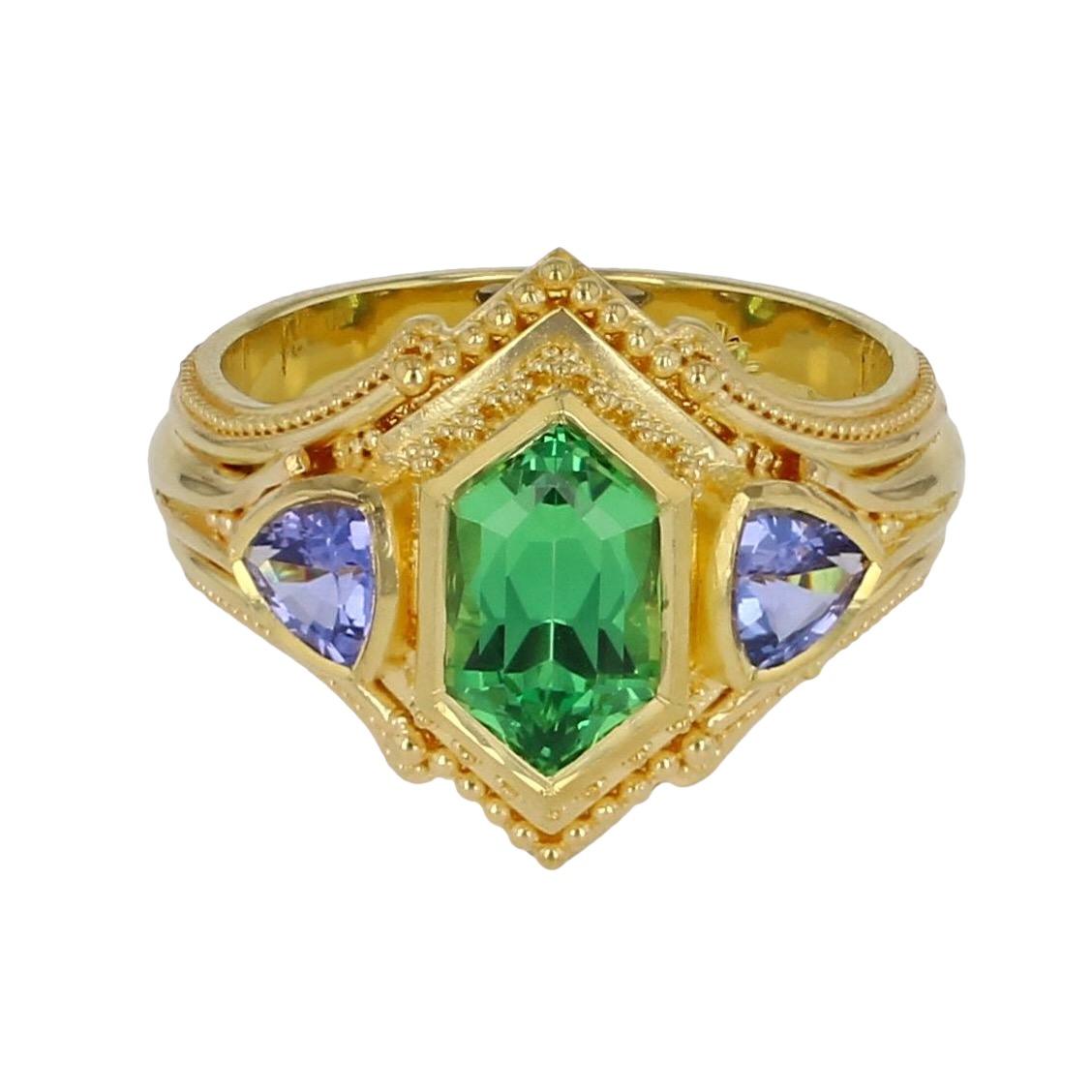 From the Kent Raible one of a kind Masterworks collection we bring you 'Dreams of Africa'. This ring features a stunning, top quality, emerald green natural Tsavorite Garnet, from Tsavo National Park in Kenya. The stone has a very unique shape,