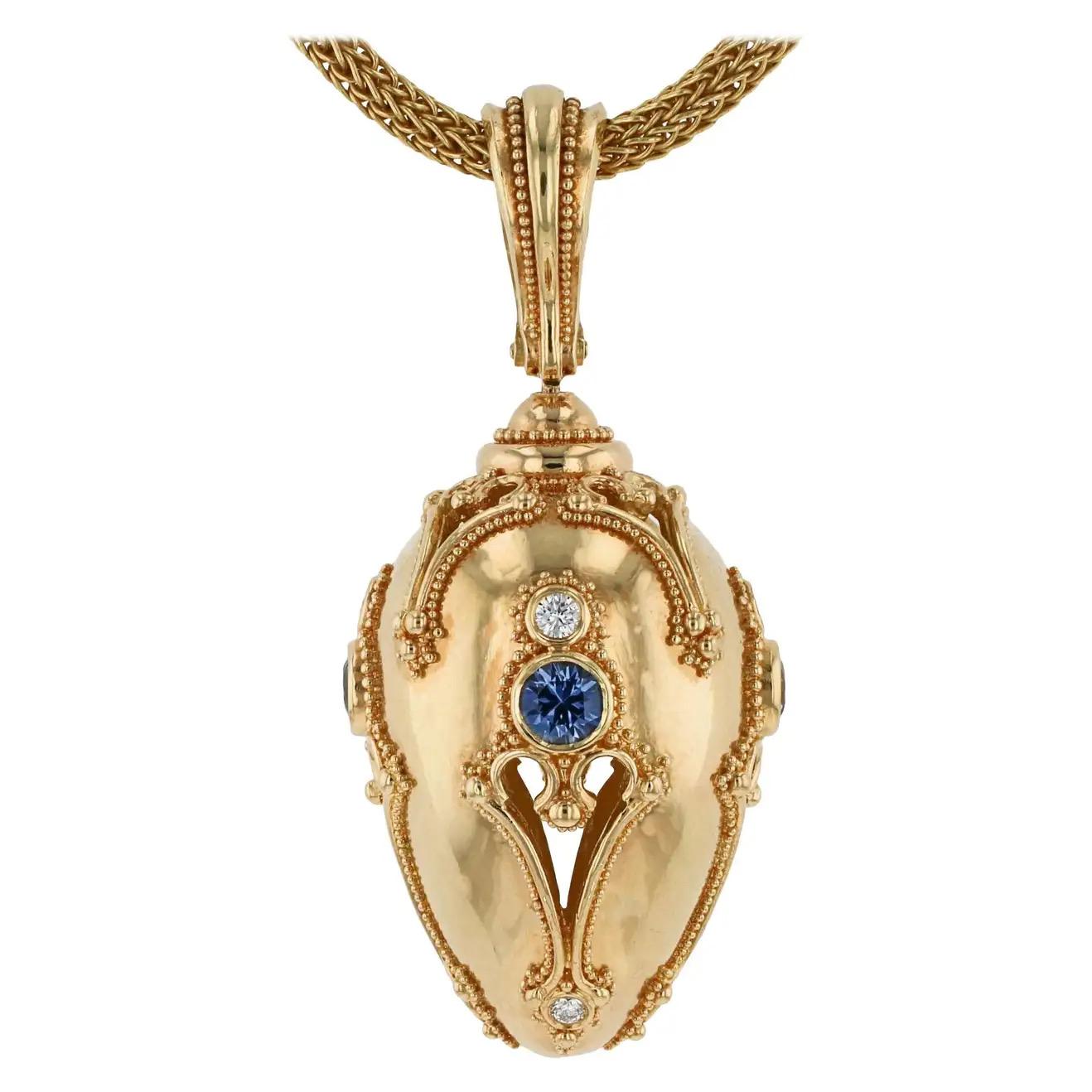 From the Kent Raible limited edition 'Studio Collection', we bring you the 'Golden Egg Pendant'. 
New beginnings have never been more beautiful! Soft Blue Sapphires and the sparkle of Diamond flash as the pendant spins and moves when worn.
In