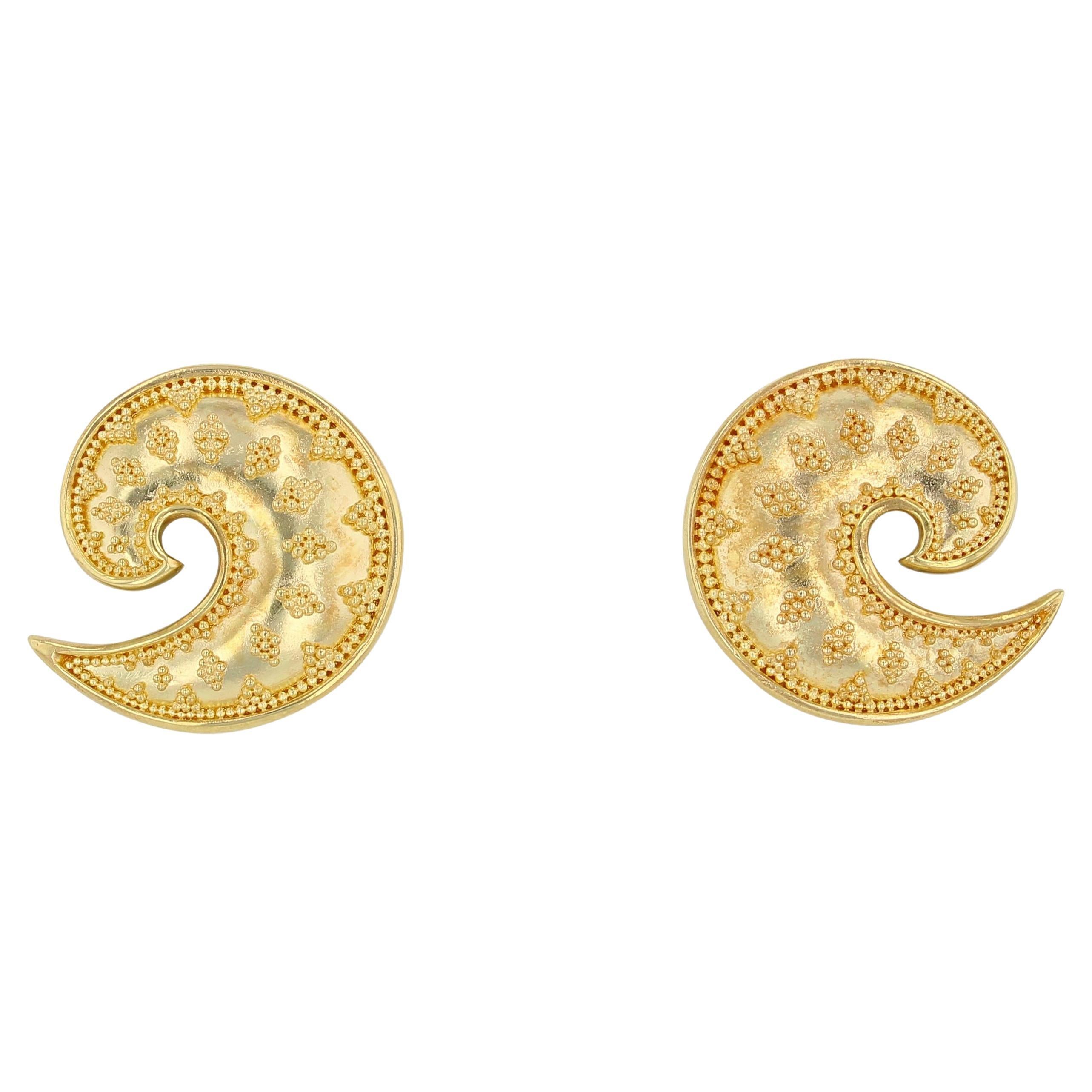 A swirl of delight is on display in these Kent Raible all gold, 18 Karat gold button earrings. In Keeping with the subtle detailing of Raible's work, note the little things that make this earring stand out... The body of this earring is not flat, it