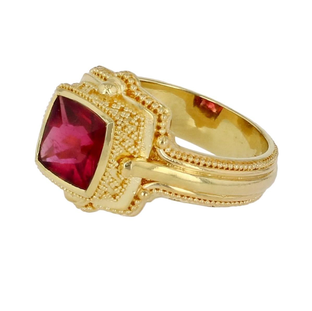 Kent Raible's square cushion cut Rubellite ring is a knock out! The gem is lively displaying reds and magentas. The artistry and craftsmanship are impeccable. Hand made by the artist himself, Raible has added layers, lines of elegant curves and fine