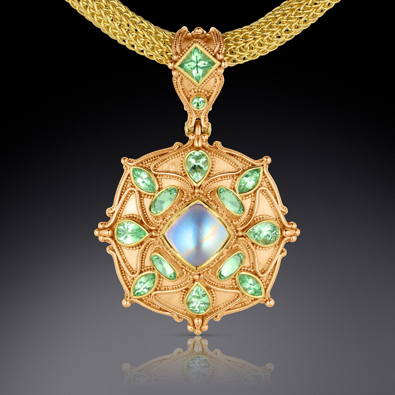 From the Kent Raible one of a kind Masterworks Collection, we bring you the 'Moonstone Mandala' pendant enhancer. At it's center is a flawless multi-colored rainbow moonstone. Accenting the Moonstone are a suite of brilliant mint green Grossular