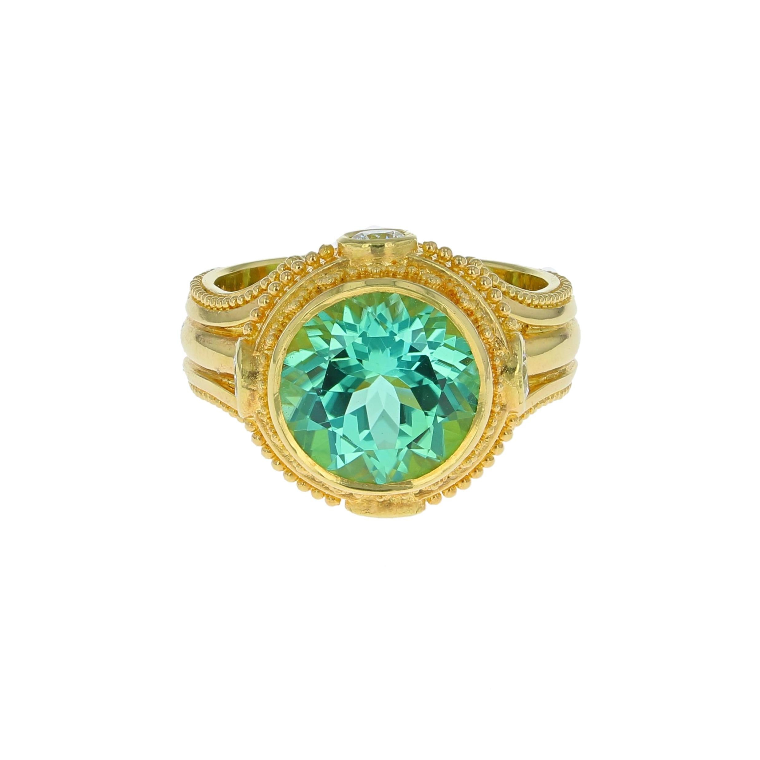 From the Kent Raible limited edition Studio Collection, we present the Prayer Wheel Ring.

The Seafoam Tourmaline, rare in this quality for its size, is accented by four Diamonds, representing the four directions, embellished with 18 karat Gold