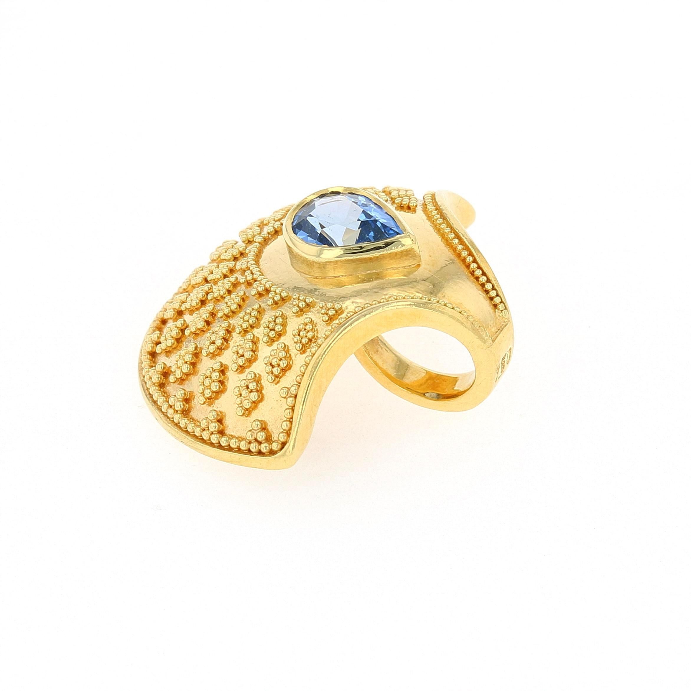 Kent Raible's necklace enhancer features beautiful tapered granules which fan out from the central pear shaped Blue Sapphire, creating an elegant shape reminiscent of an alluring Japanese fan or a cockleshell pattern.
Wear on one of our hand woven