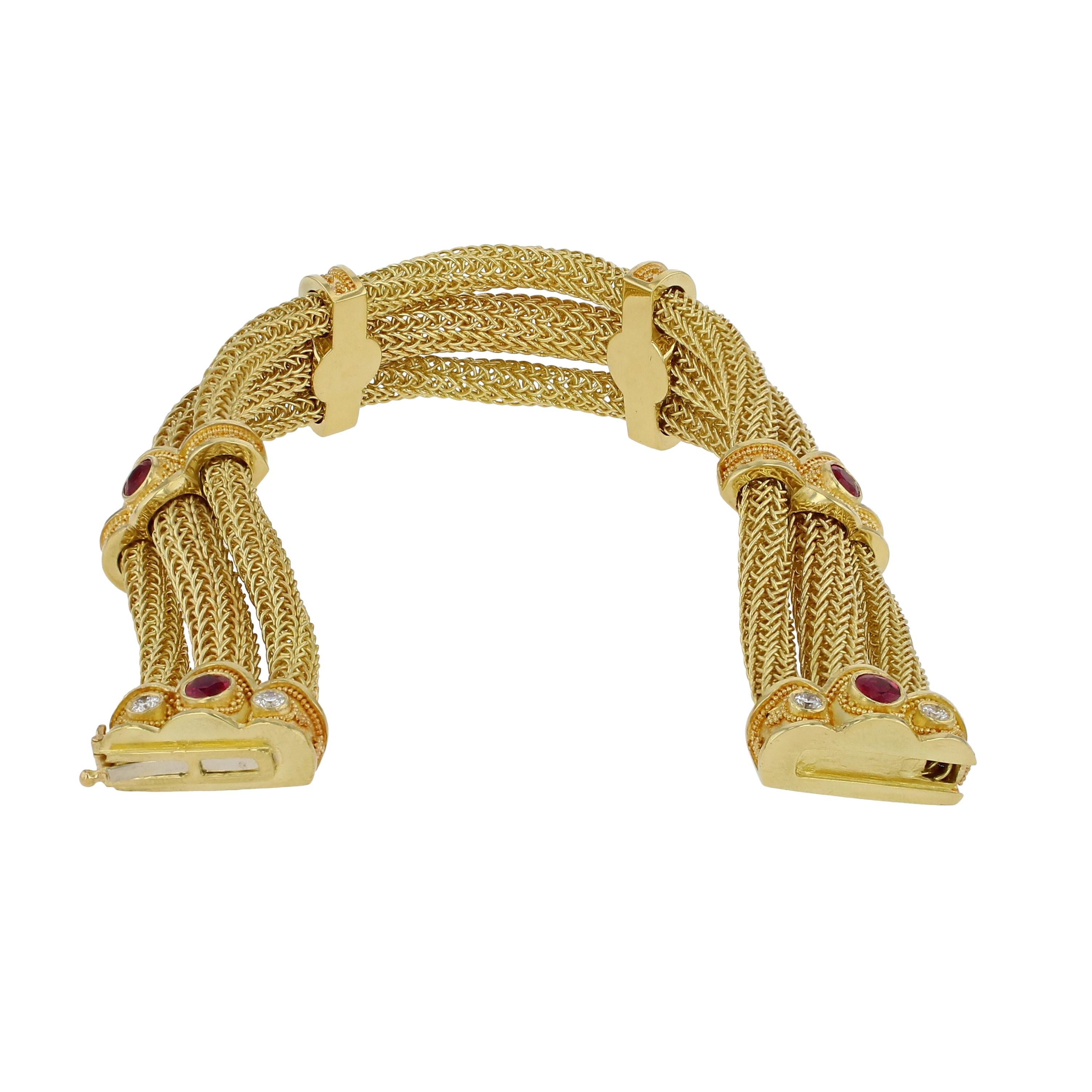 This stunning Kent Raible bracelet has been intricately and finely created in our Washington state studio. The supple hand woven chains are wrapped in finely granulated golden bridges, each displaying a rich red Burmese Ruby at its center. As we
