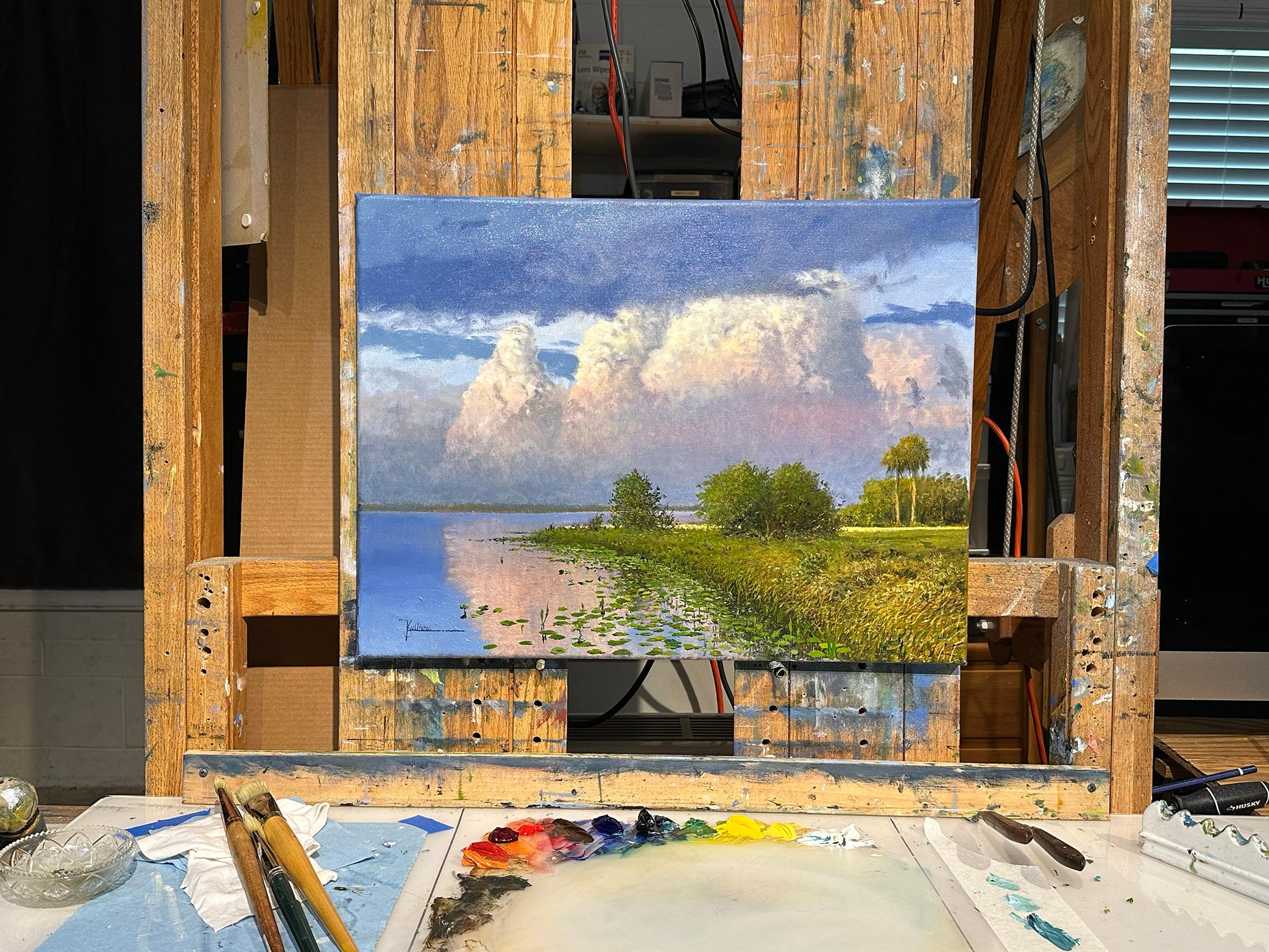 <p>Commentaires de l'artiste<br>Des palmiers verdoyants bordent un lac, créant une scène d'après-midi sereine. Les nuances de lavande se mêlent aux nuages corail et roses, reflétant la chaude lueur du soleil couchant et ajoutant un effet