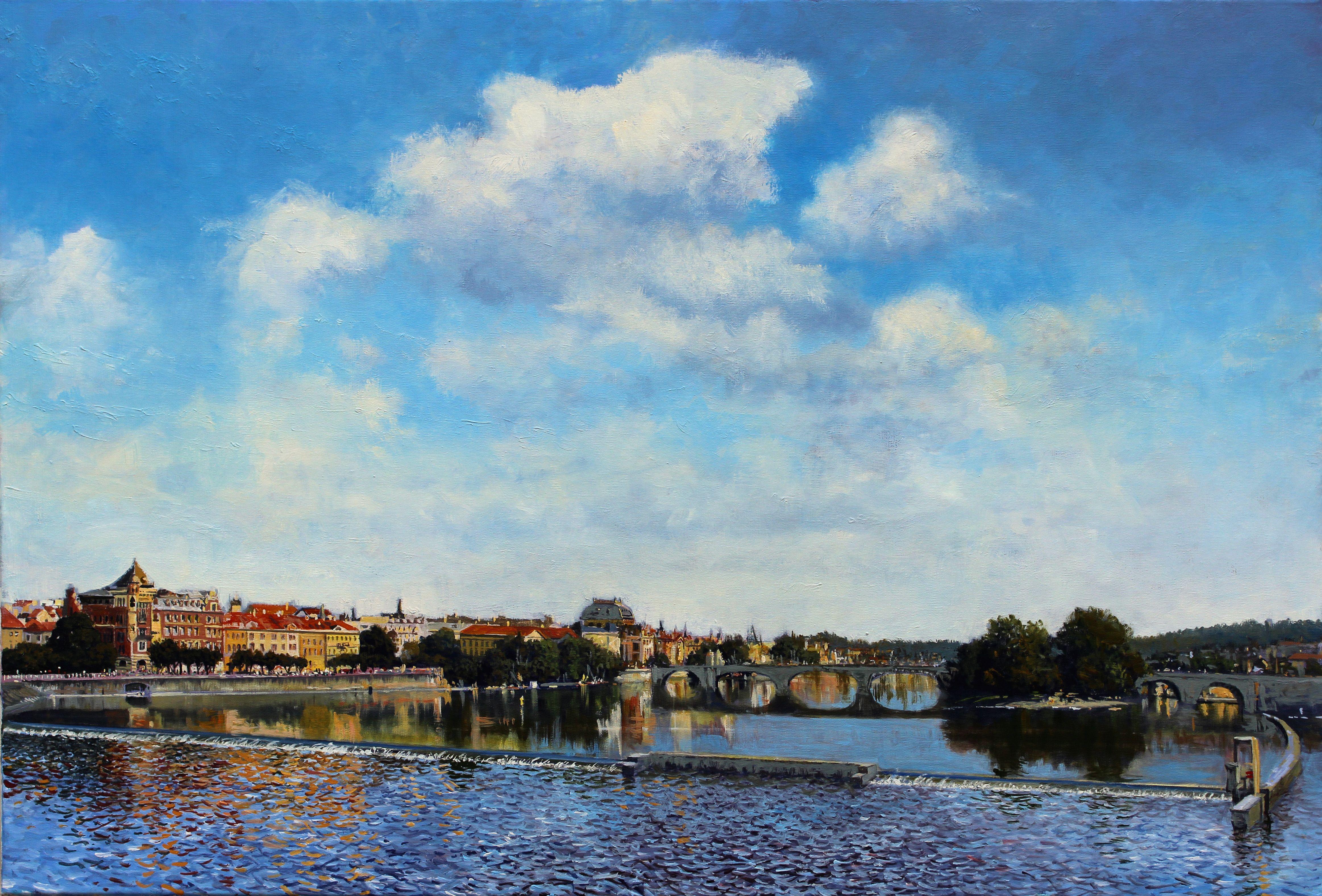 A sunny day in Prague. Clouds move silently over the gentle water of the Vltava river. The bridge was built between 1899 â€“ 1901 and replaced the earlier Francis I Chain Bridge (built in 1841). It was famously opened on 14th June 1901.  The bridge