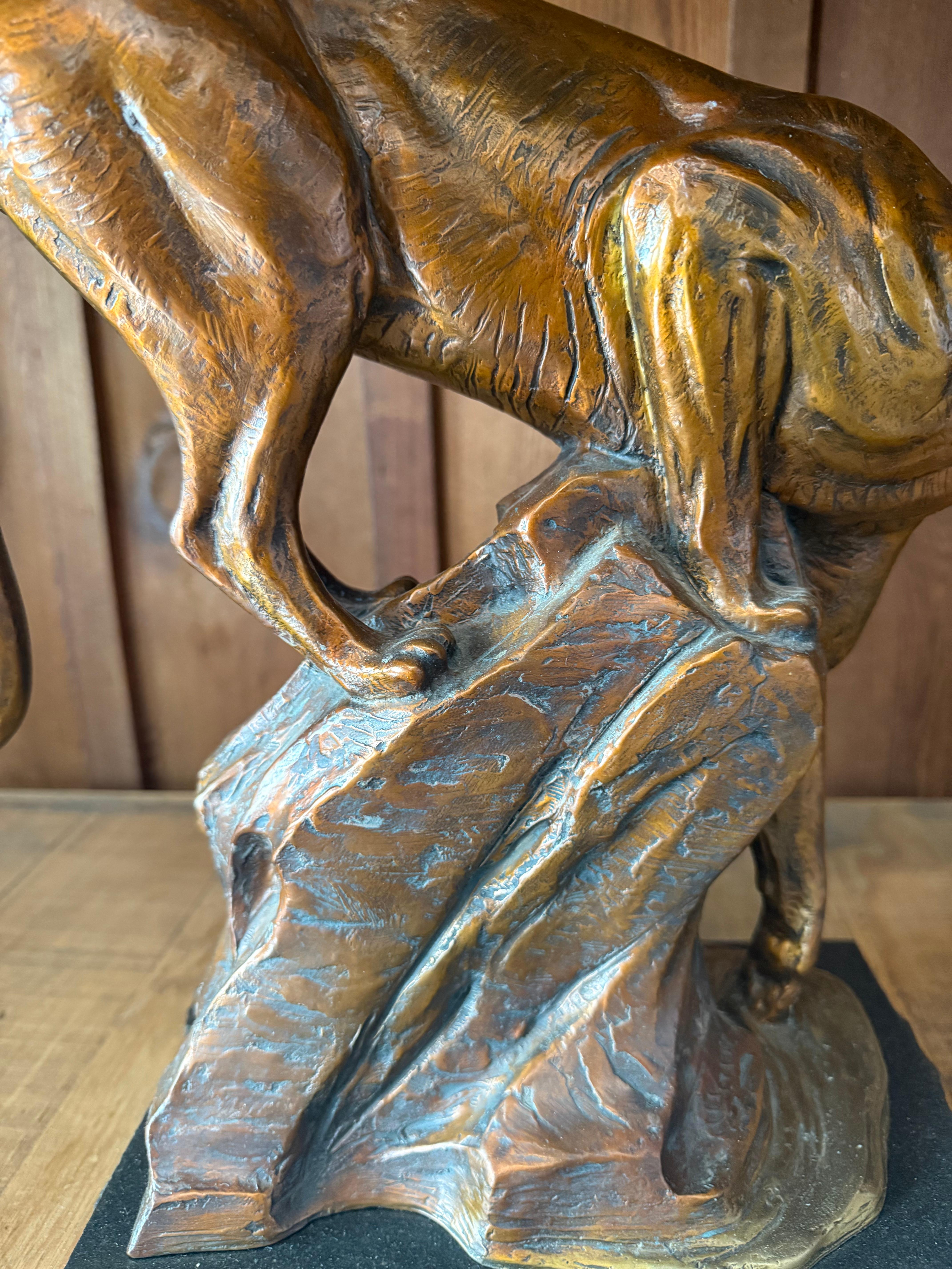 By the River by Kent Ullberg is a captivating bronze sculpture that embodies the stealth and elegance of a mountain lion in its natural environment. With its fluid posture and intricate details, the piece highlights the animal’s grace and strength