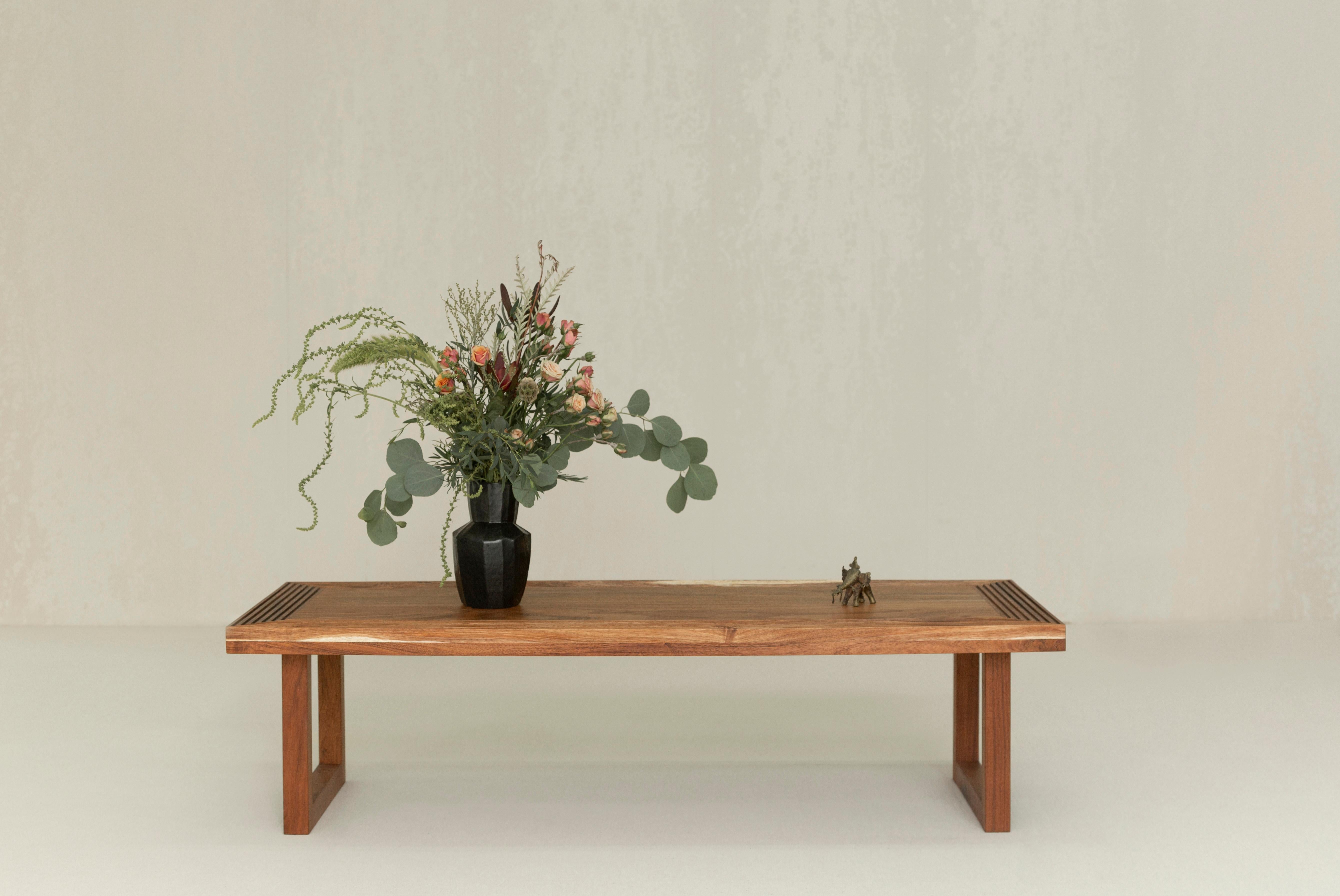 The Kenta coffee table is inspired by tea ceremonies, combining simplicity and great attention to detail. It is made out of a Mexican wood called Tzalam. It has exquisite detailing on the top with fine ridges.