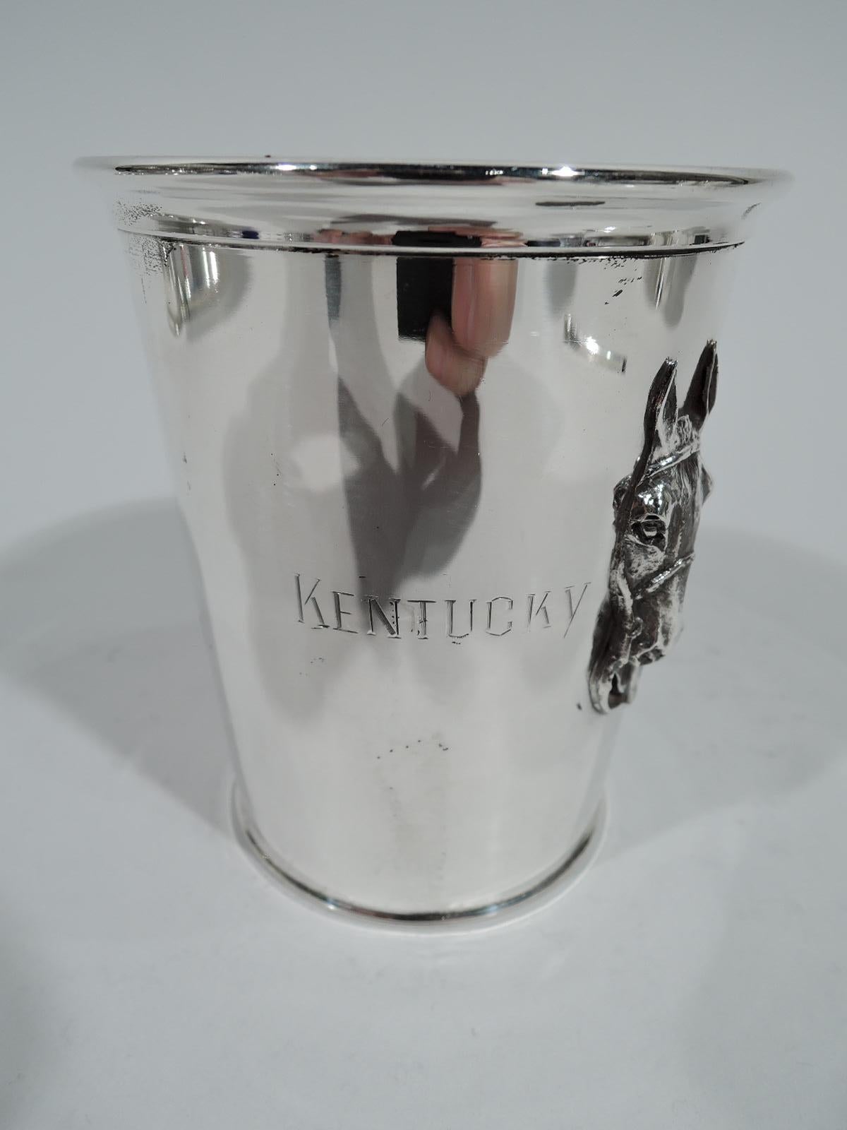 Horse head sterling silver mint julep cup. Made by Webster in North Attleboro, circa 1930. Straight and tapering sides, and molded rim. Applied horse head between engraved phrase “Kentucky Derby”. Fully marked and numbered 8555. Weight: 3.5 troy