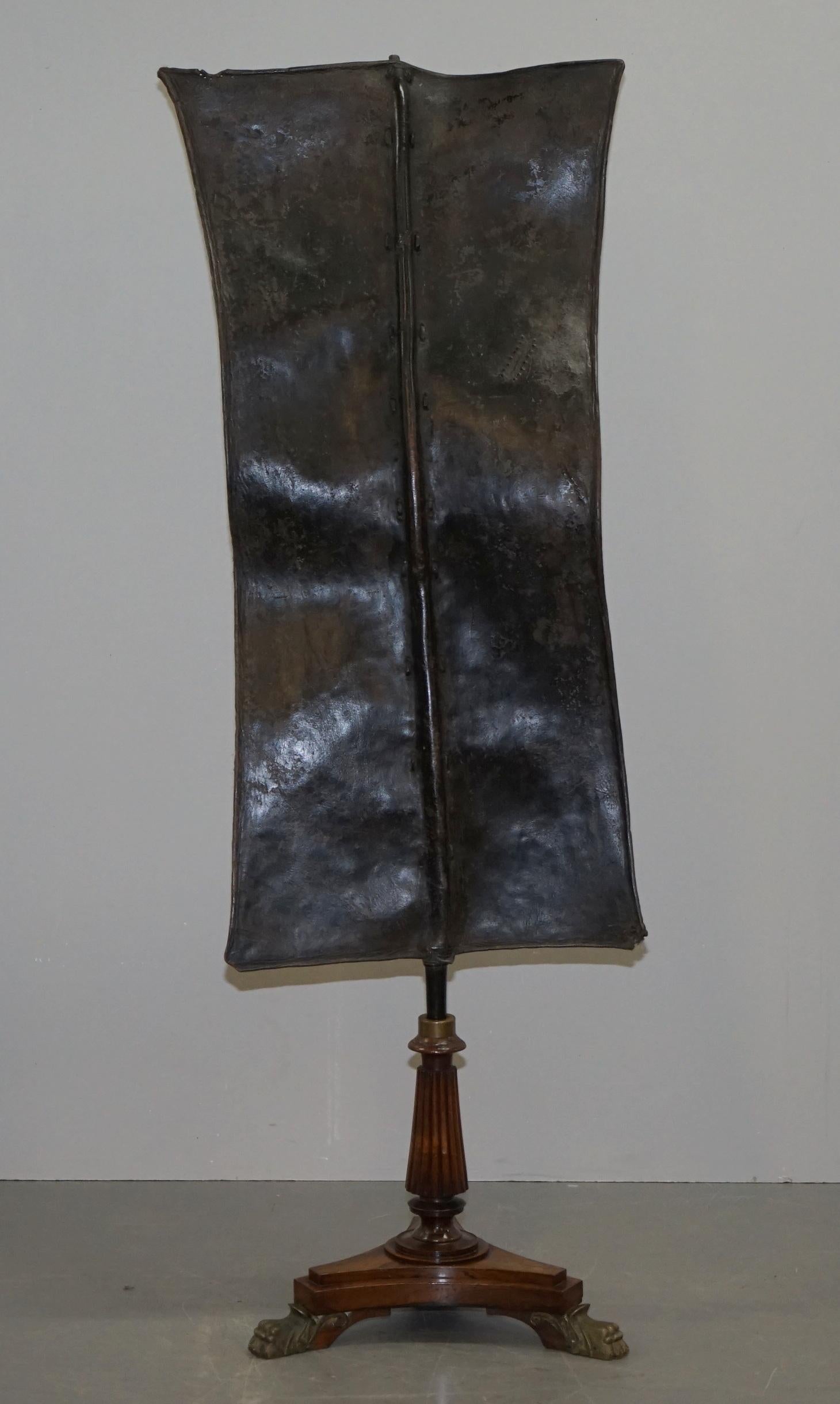 We are delighted to offer for sale this lovely original handmade Kenyan Turkana leather and iron bound fighting shield which has been expertly mounted to a Gillows quality hardwood and brass Regency circa 1810 pedestal base 

A very fine example,