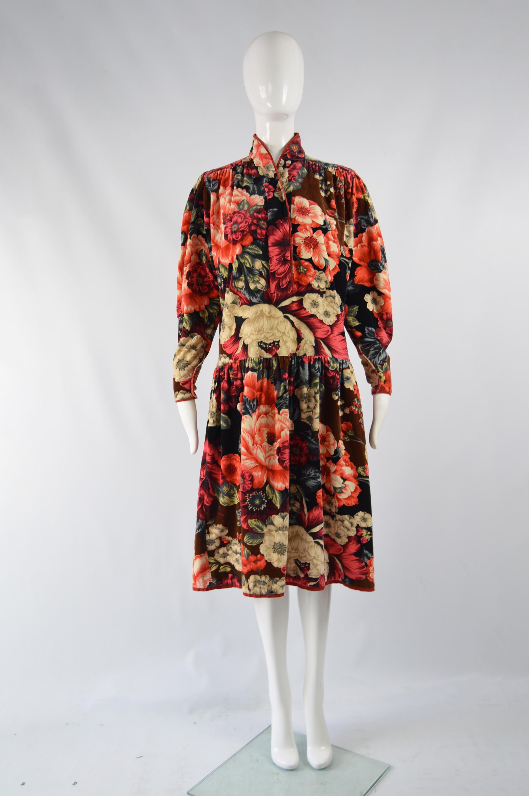 A beautiful vintage womens boho oversized dress from the 70s by iconic fashion designer, Kenzo. In a black, boldly floral printed velvet with a red corduroy trim, dropped waist and puff sleeves. 

Size: Marked M but it is meant to have an oversized