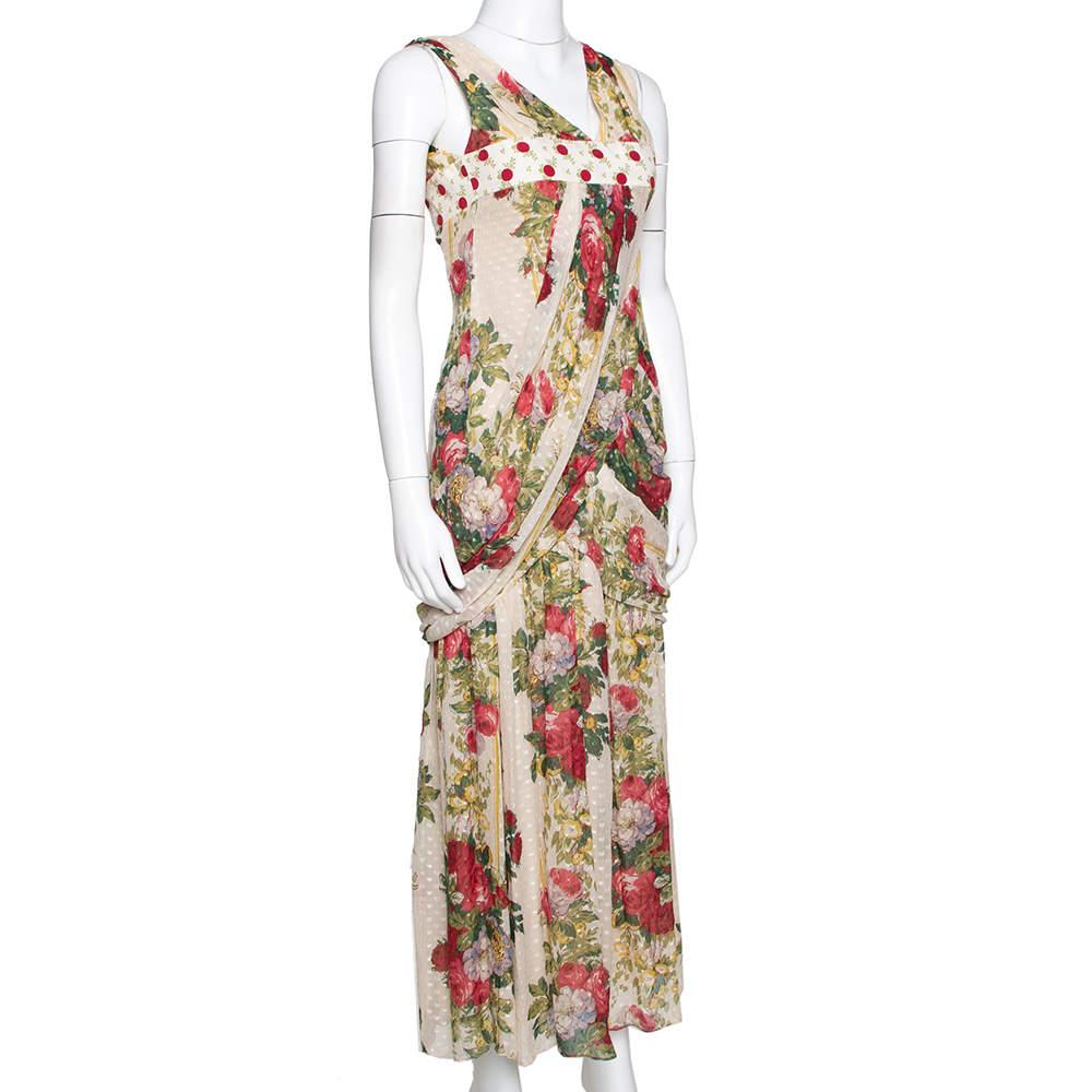 This playful maxi dress by Kenzo is perfect for fun outings with your friends. Crafted from a silk blend  it has a pure silk lining and comes in a lovely shade of beige. The draped dress has a textured exterior with polka dots and a floral print. It