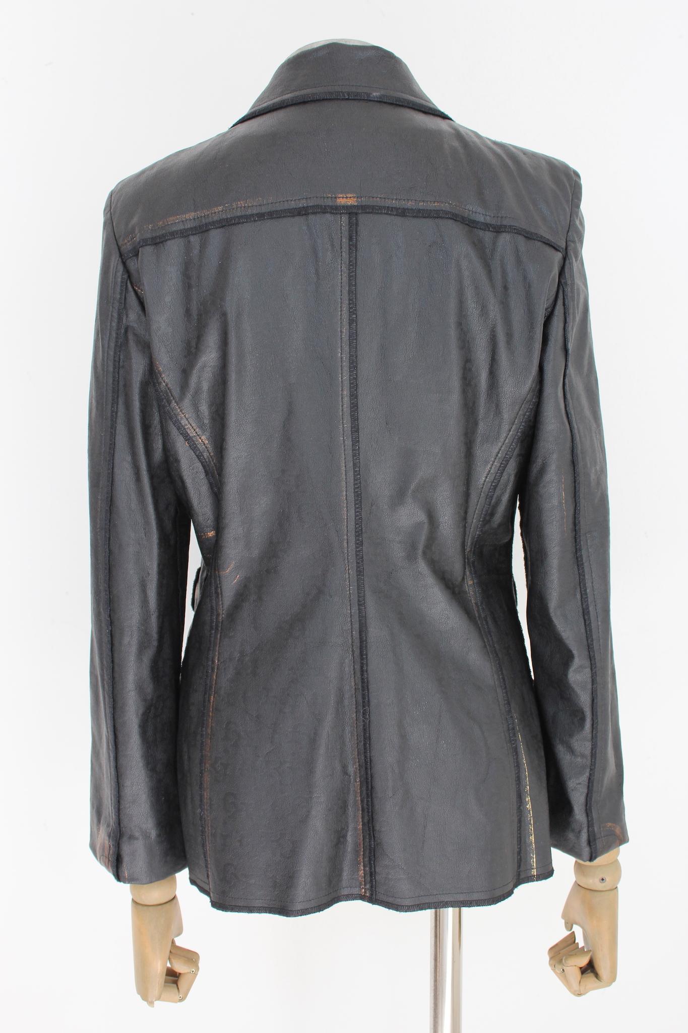 Kenzo vintage 80s faux leather flared jacket. Soft jacket, black with bronze shades, hidden clip buttons. Fabric 50% cotton, 50% polyurethane, internally unlined. Made in Italy.

Size: 40 It 6 Us 8 Uk

Shoulder: 40 cm
Bust/Chest: 46 cm
Sleeve: 58