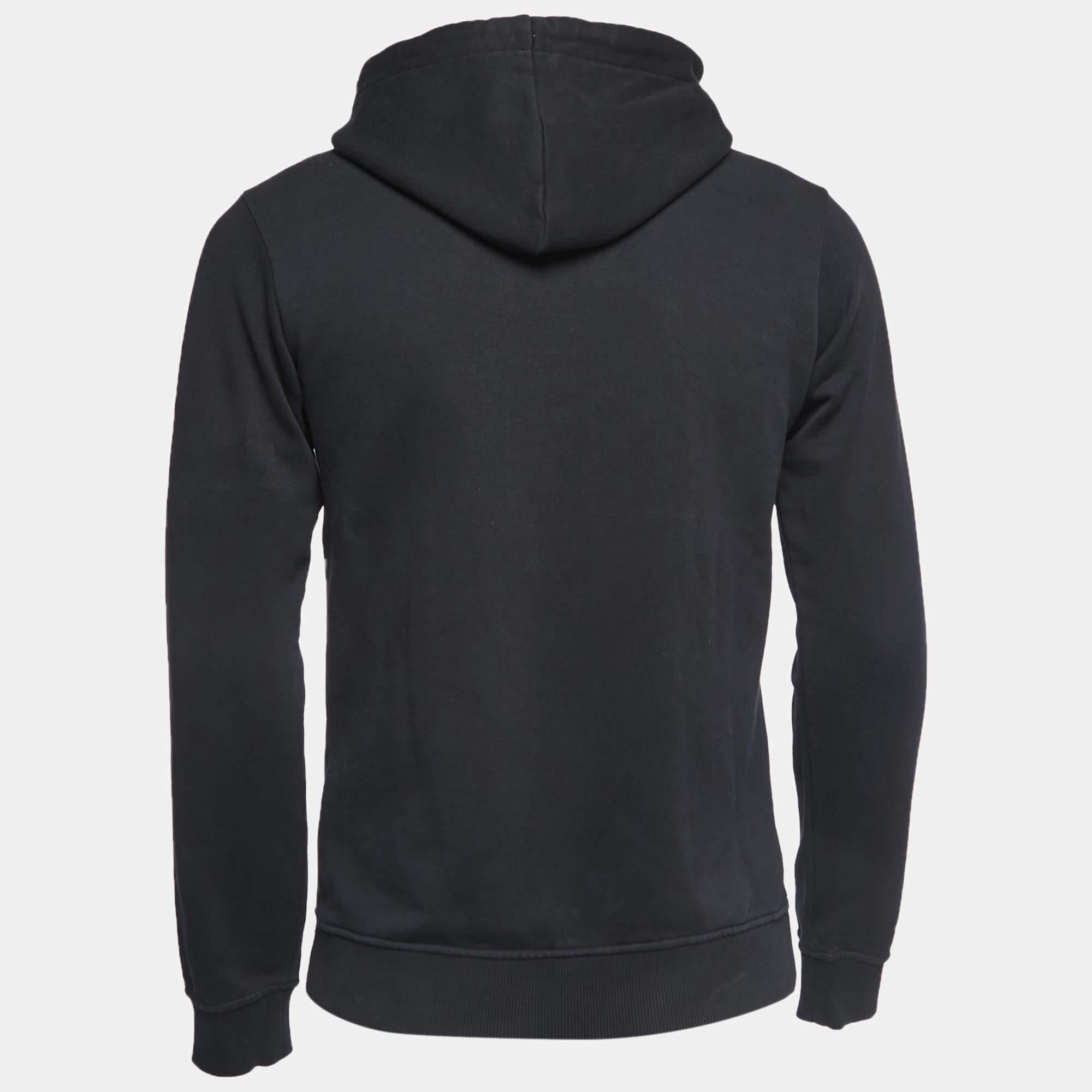 The Kenzo hoodie exudes urban chic. Crafted from premium cotton knit, it features a sleek black hue, a comfortable hood, and the iconic Kenzo logo delicately embroidered, striking the perfect balance between style and comfort.