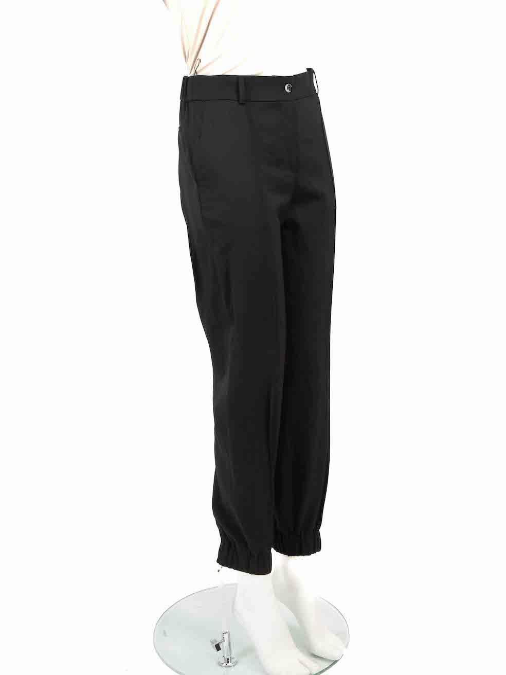 CONDITION is Very good. Minimal wear to trousers is evident. Slight discolouration to the brand label on this used Kenzo designer resale item.
 
 Details
 Black
 Wool
 Trousers
 Tapered leg
 High rise
 Elasticated waistband and cuffs
 2x Side